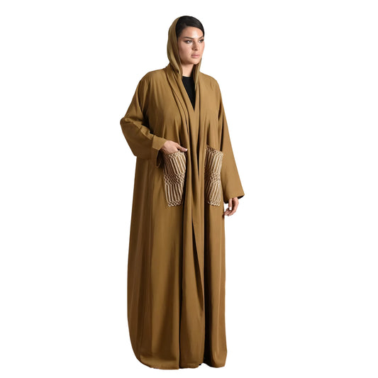 Woman wearing a long olive green abaya with pockets on a white background
