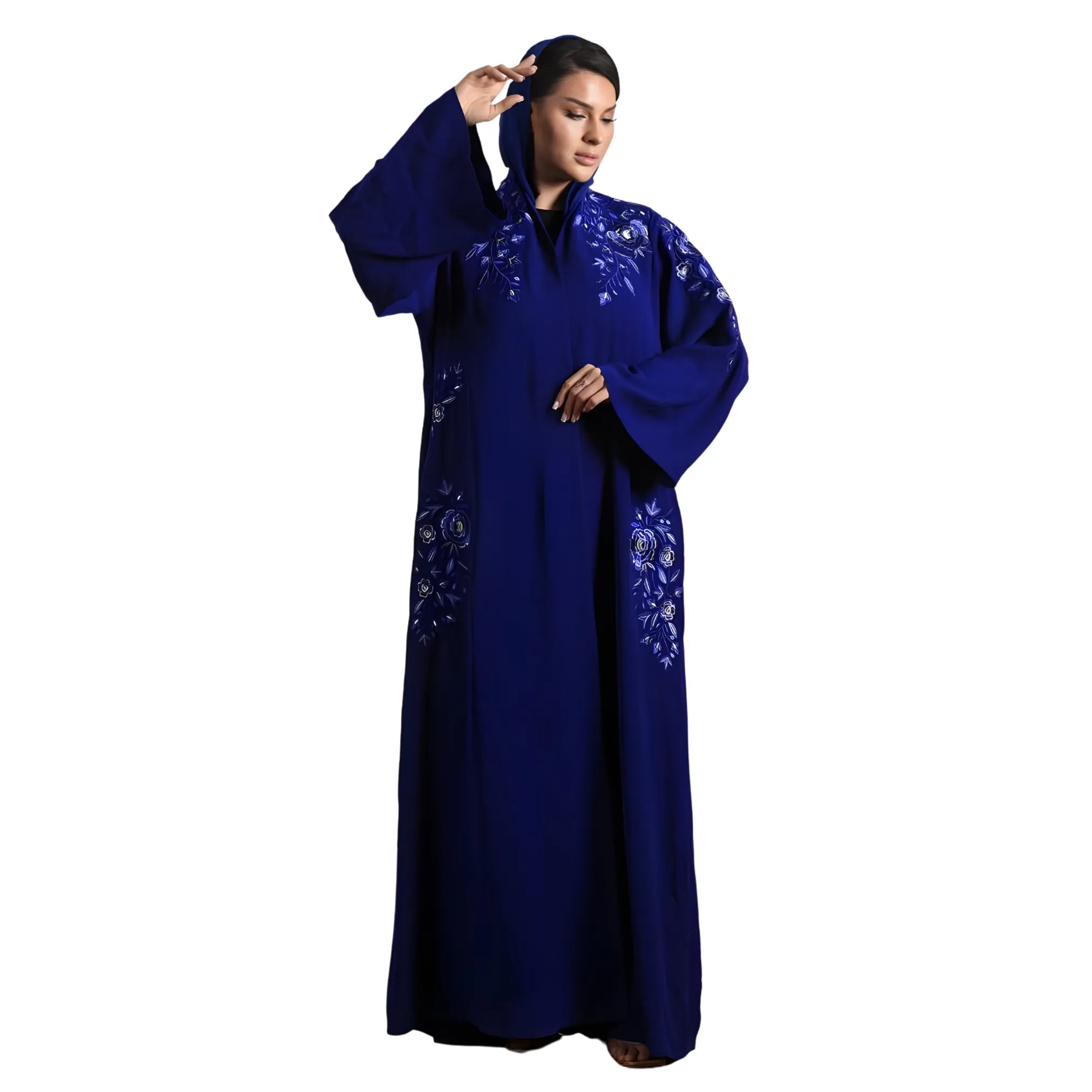 Woman wearing a blue embroidered abaya on a white background