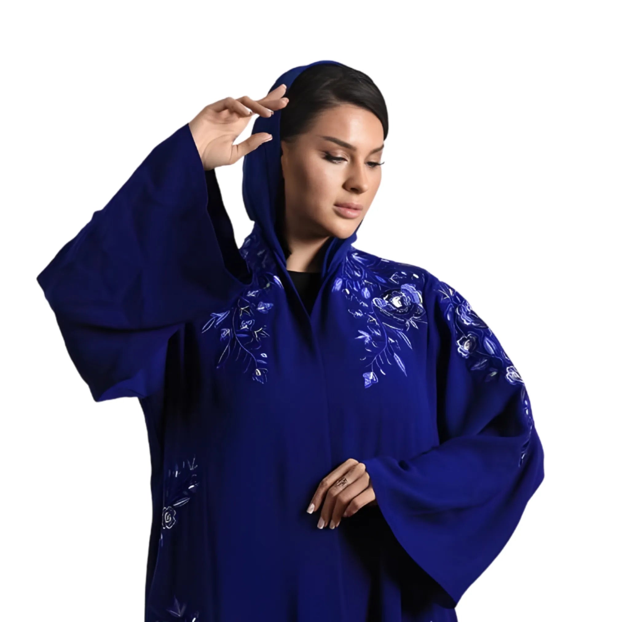 Woman wearing a blue embroidered abaya on a white background