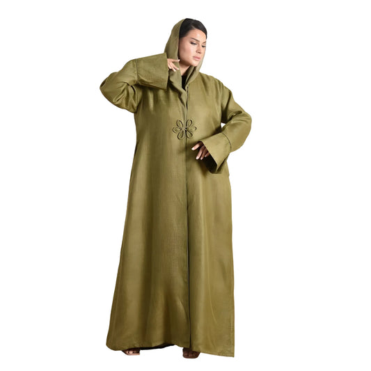 Woman wearing a long olive green coat with a hood on a white background