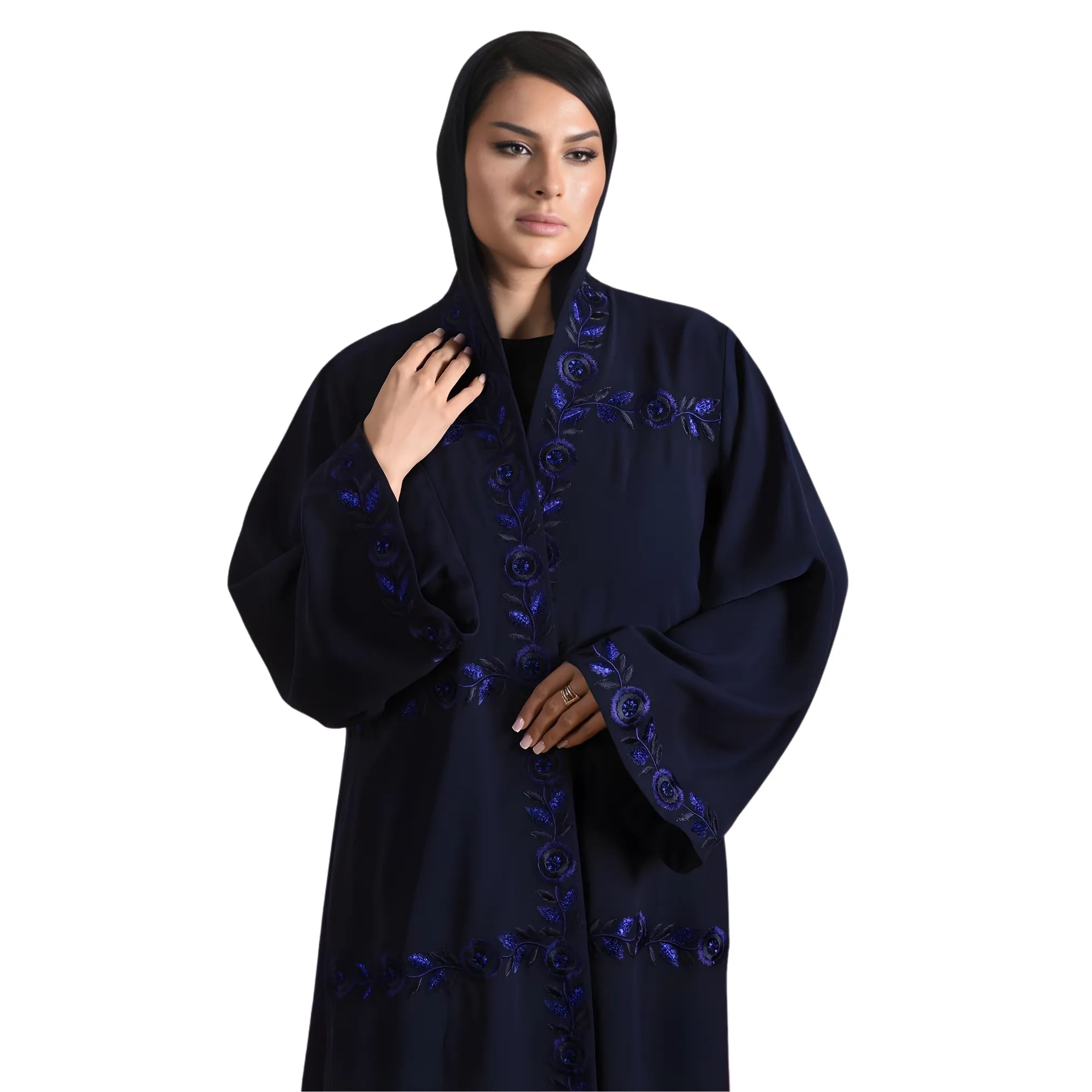 Woman wearing a dark blue embroidered abaya on a white background