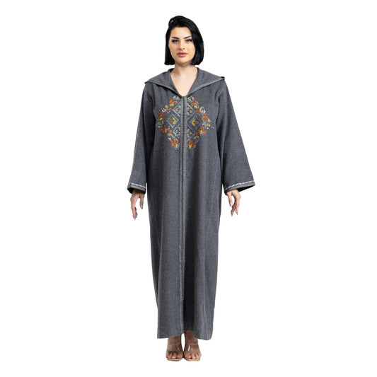 Woman wearing a gray embroidered jalabiya on a white background