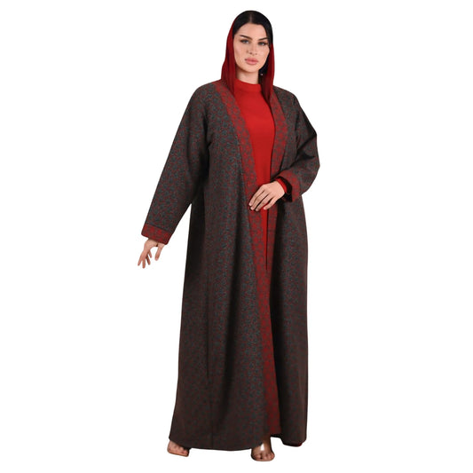 Woman wearing a long brown and red abaya on a white background