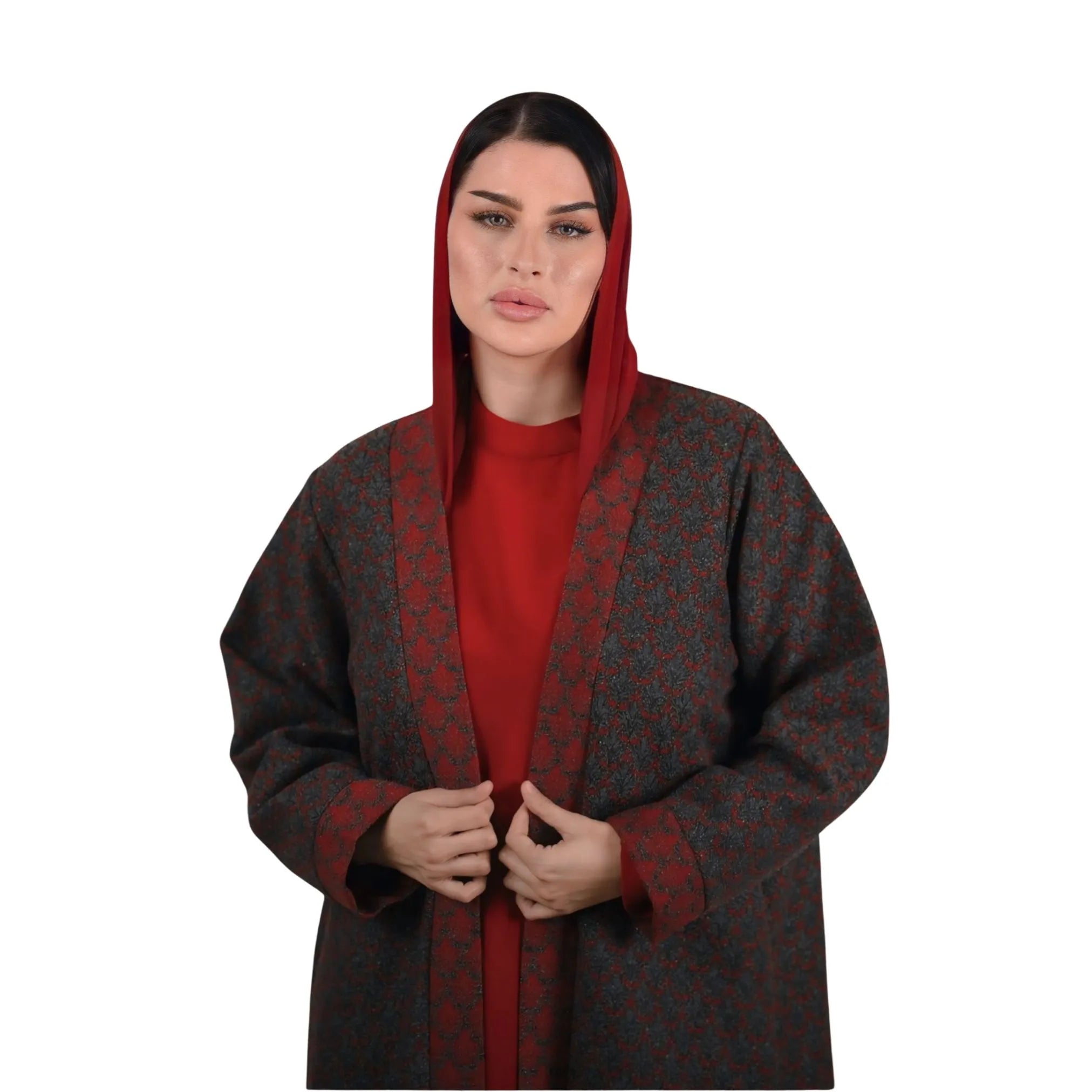 Woman wearing a red and brown patterned abaya on a white background