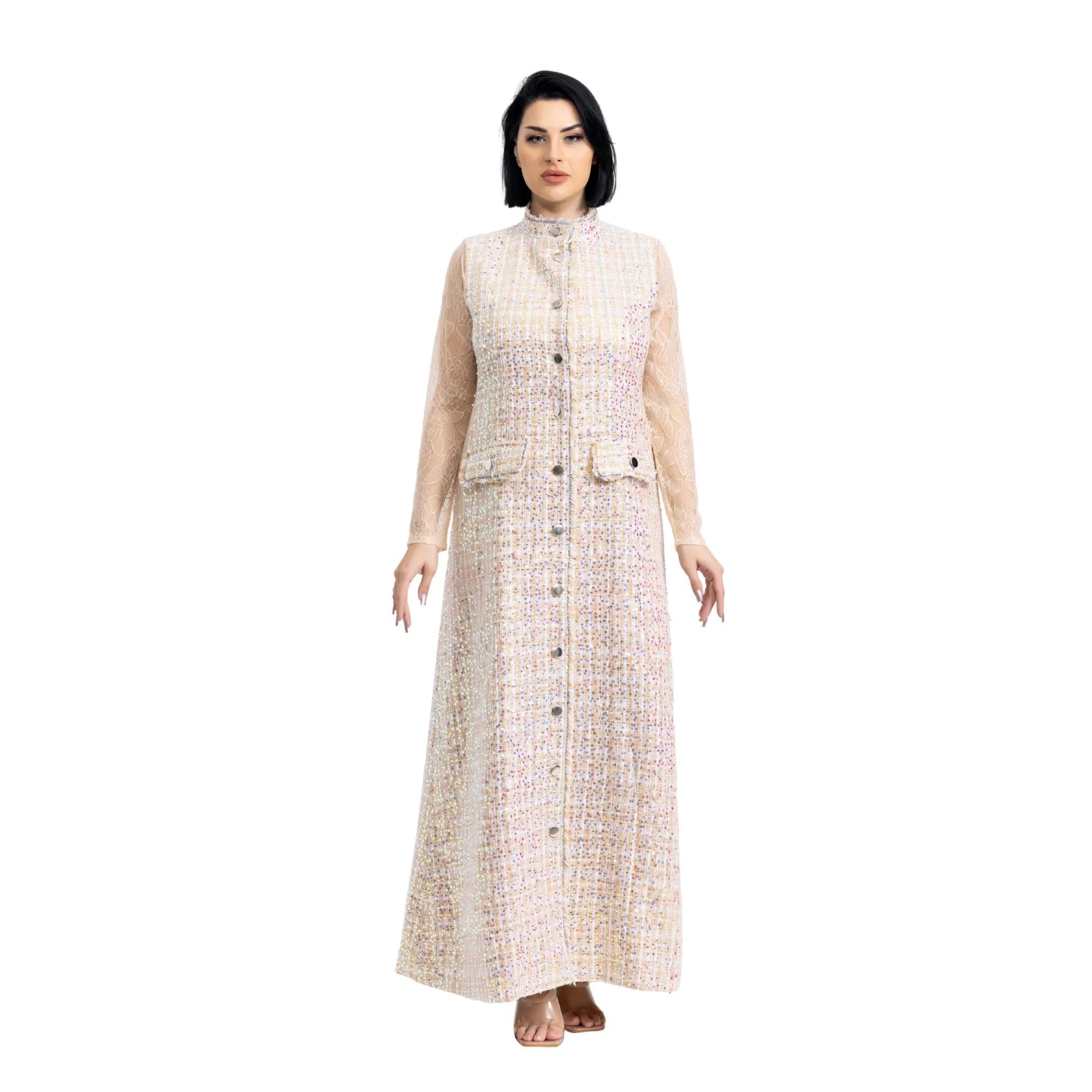 Woman wearing a long, light-colored dress with a pattern on a white background