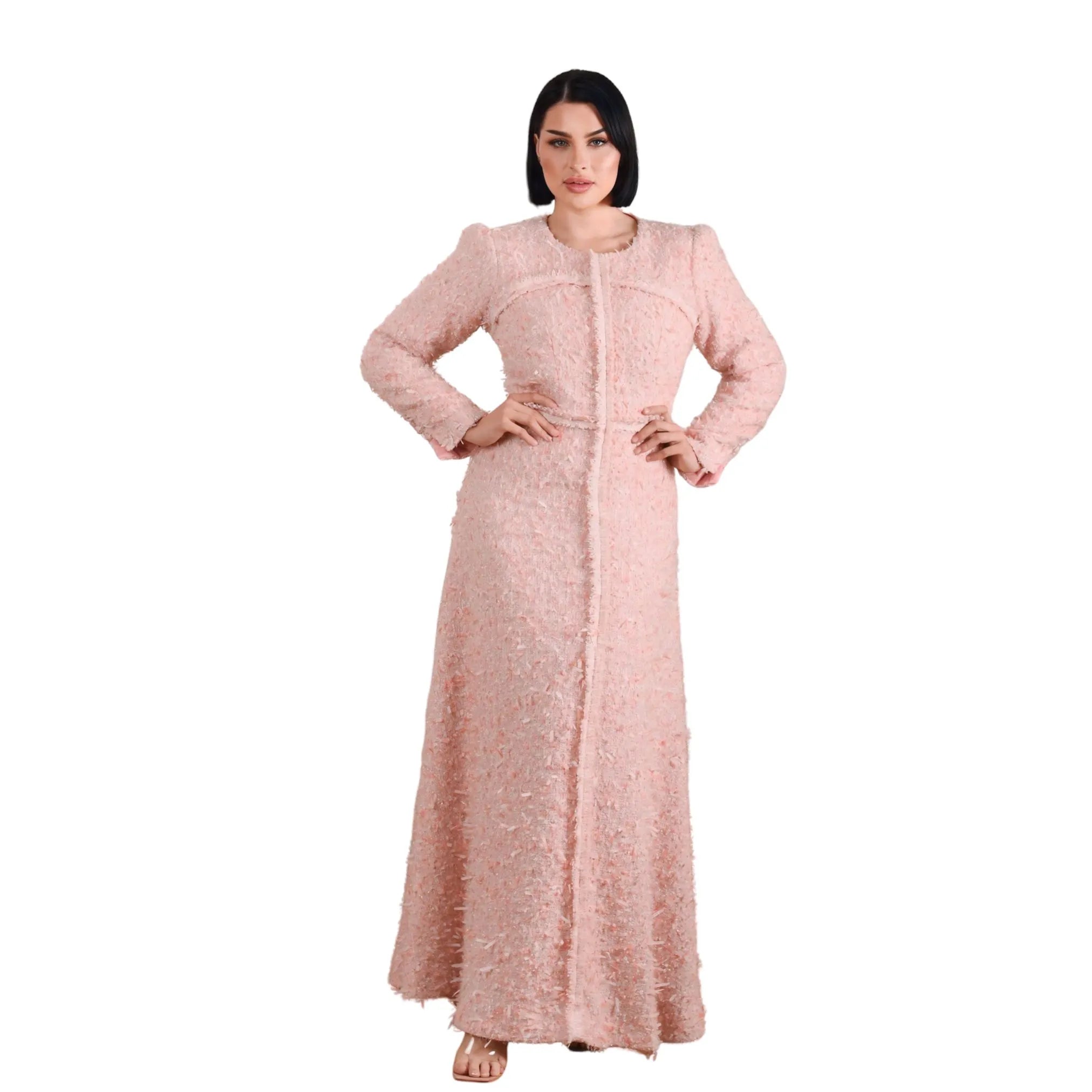 Woman wearing a long pink dress on a white background