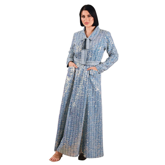 Woman wearing a long, patterned dress on a white background