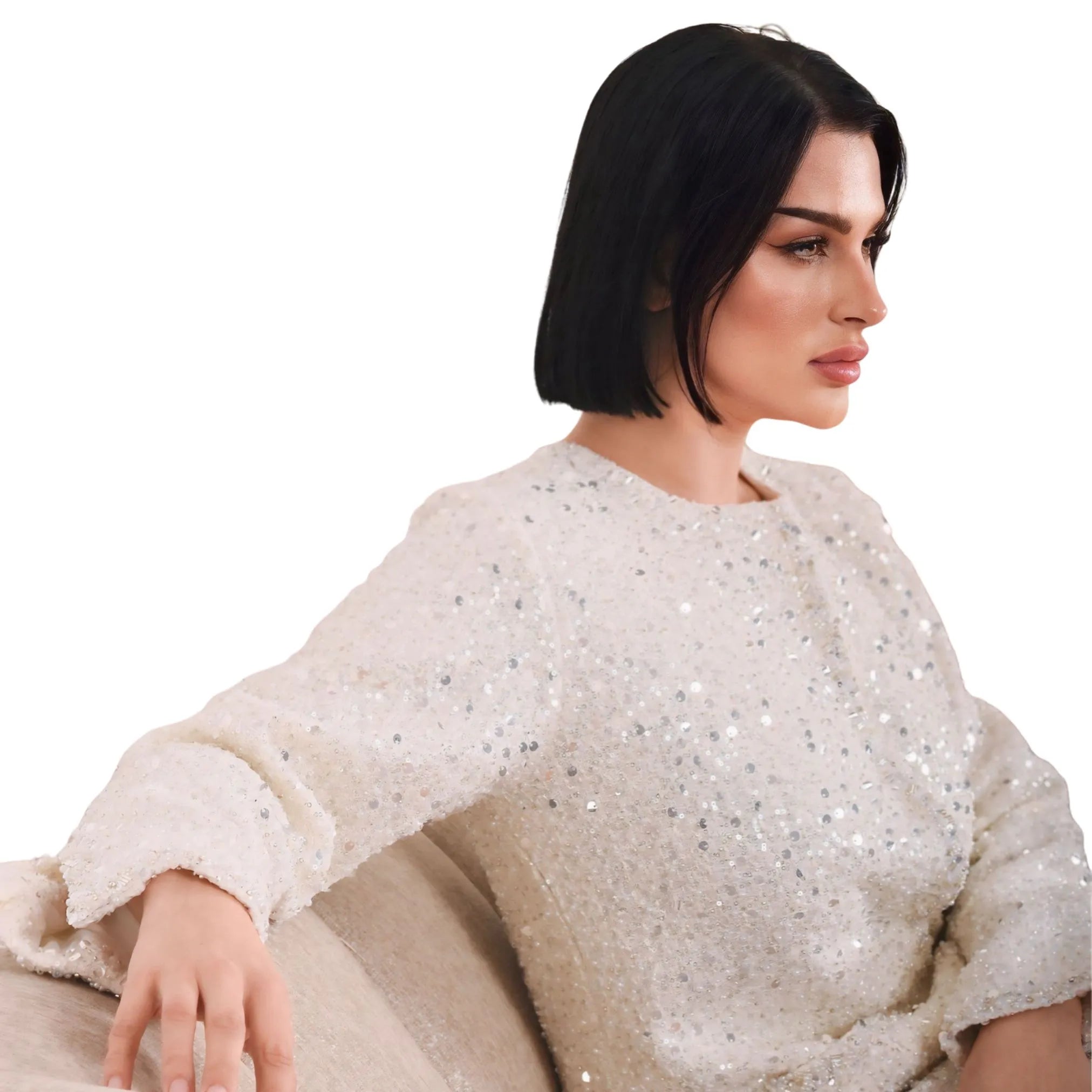 Woman wearing a white sequined top on a white background