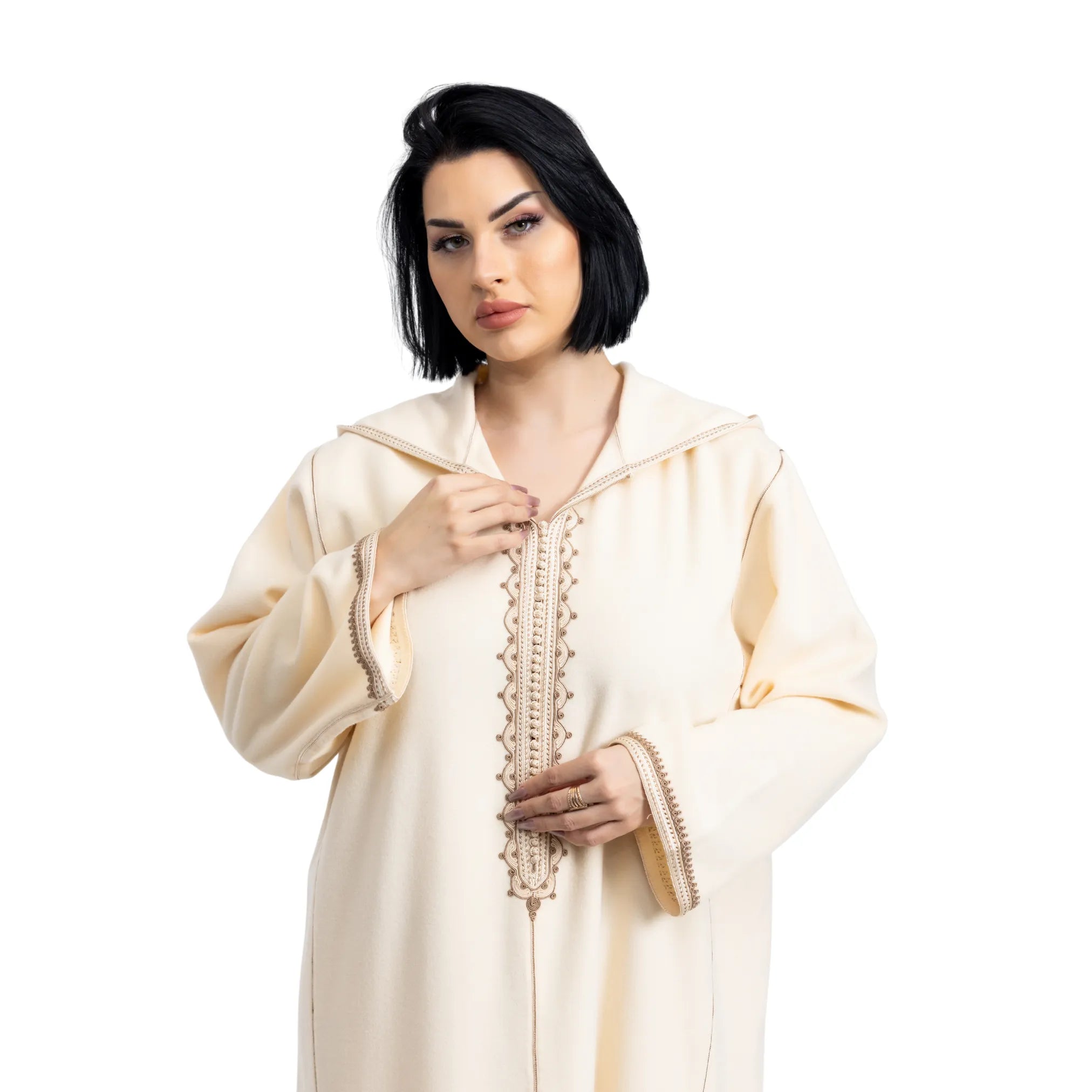 Woman wearing a cream-colored traditional jalabiya outfit with intricate patterns on a white background