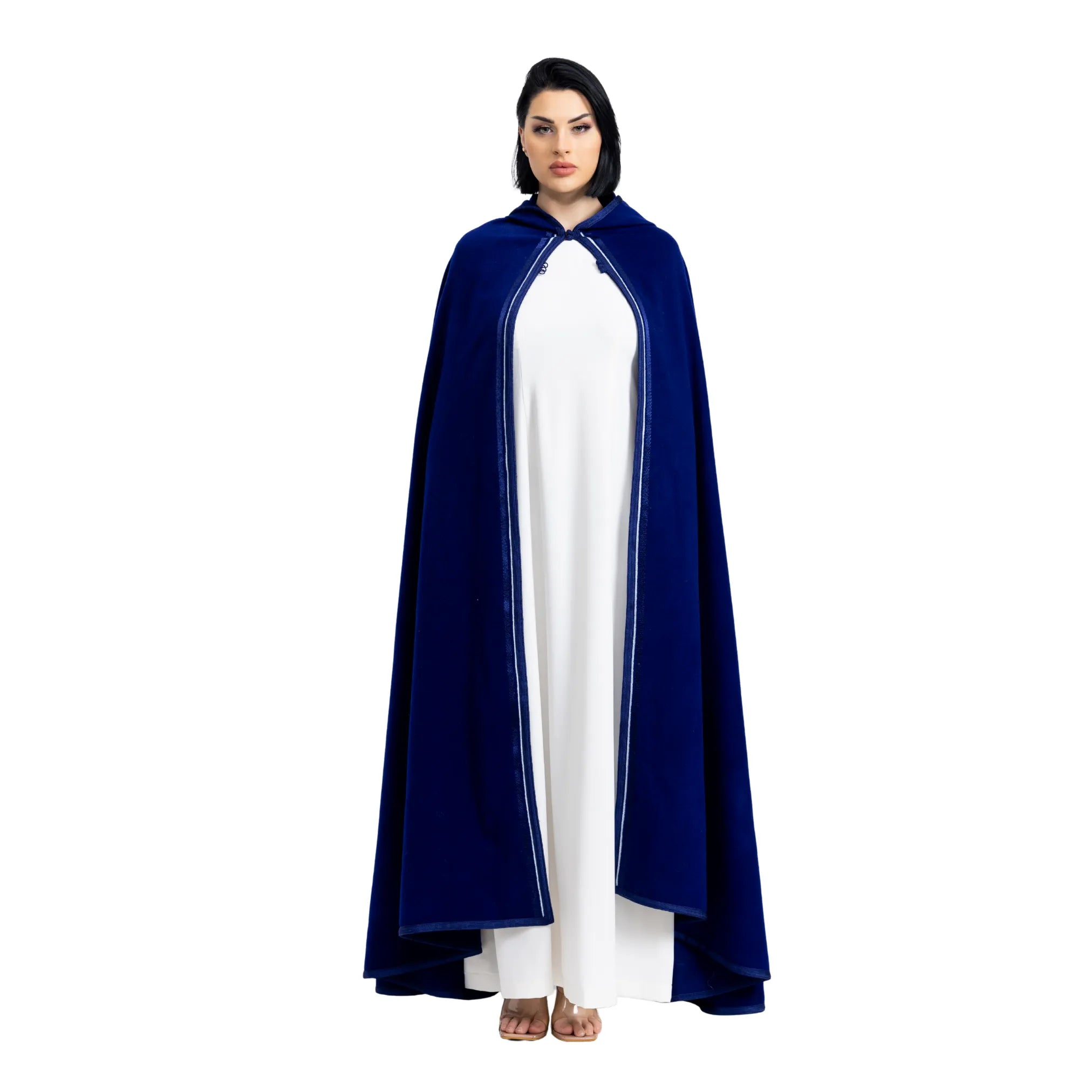 Person wearing a blue cape over a white jalabiya on a white background
