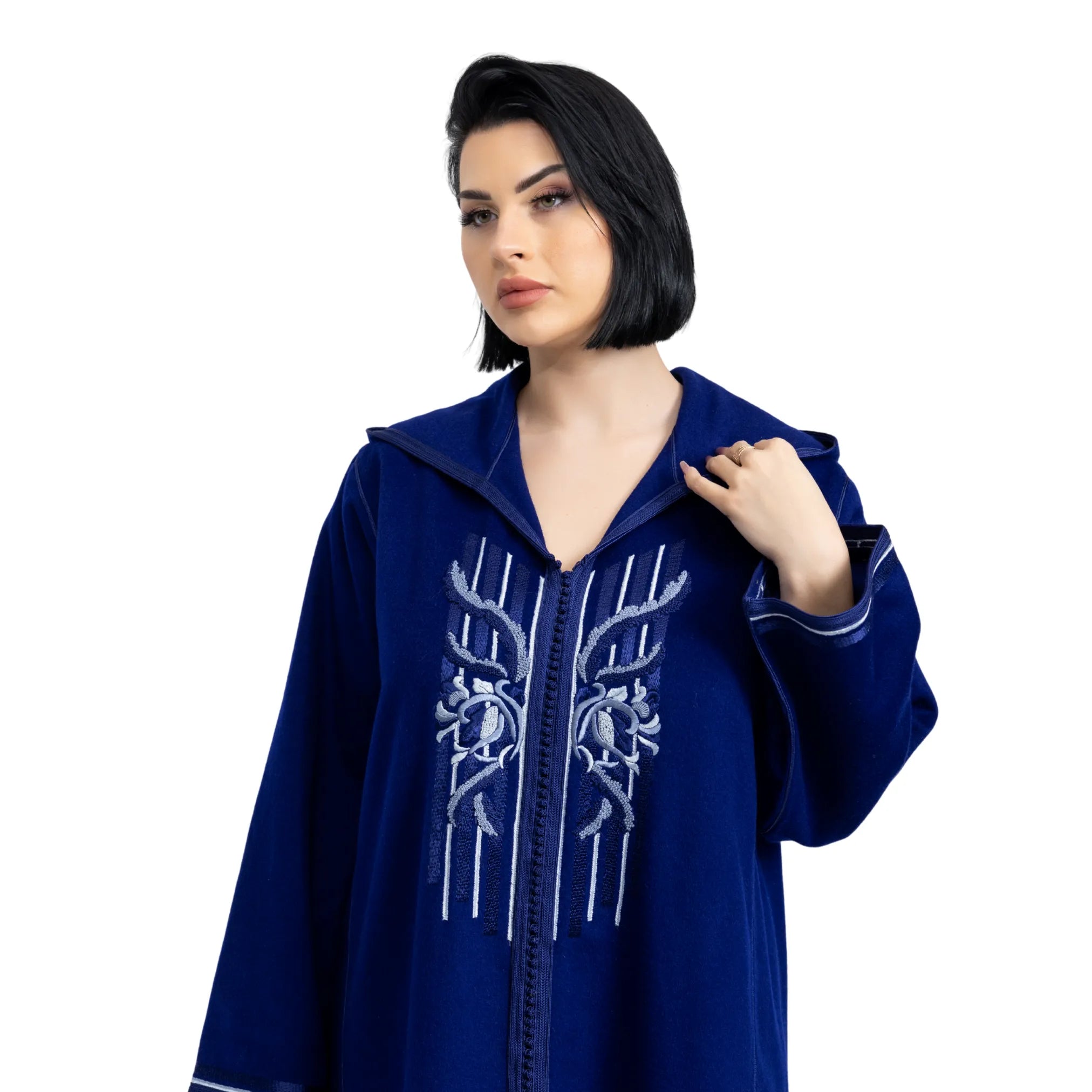 Woman wearing a blue embroidered jalabiya on a white background