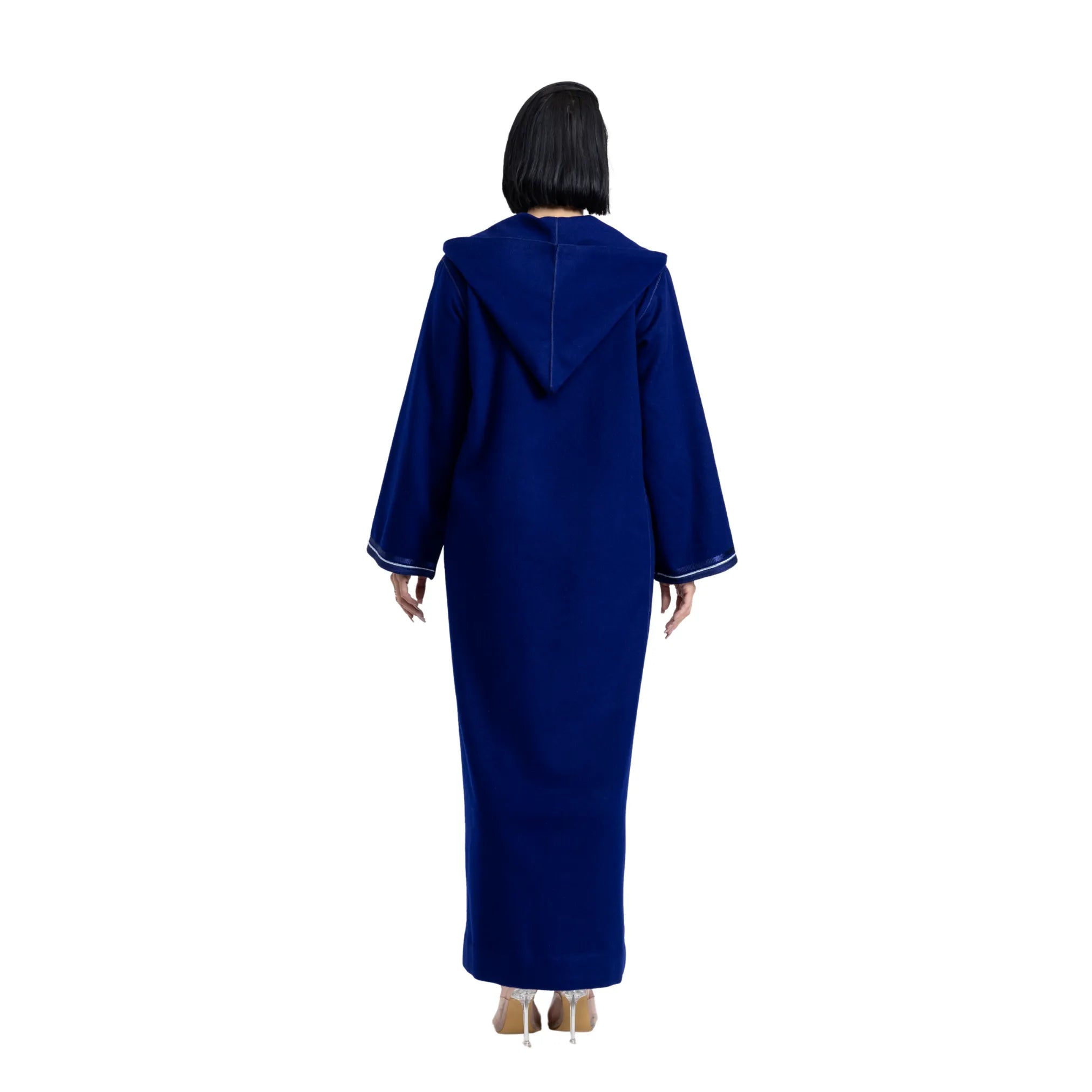 Person wearing a blue jalabiya with a hood on a white background