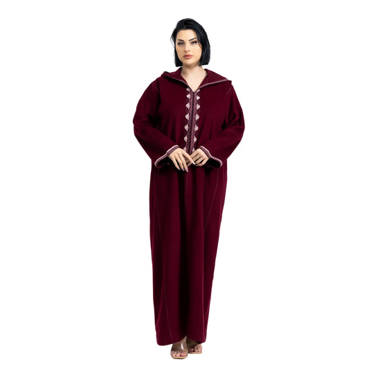 Woman wearing a burgundy jalabiya with a white background