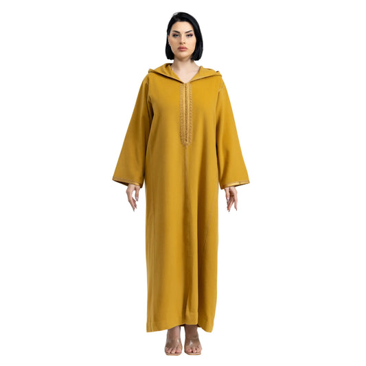 Woman wearing a mustard yellow hooded jalabiya on a white background