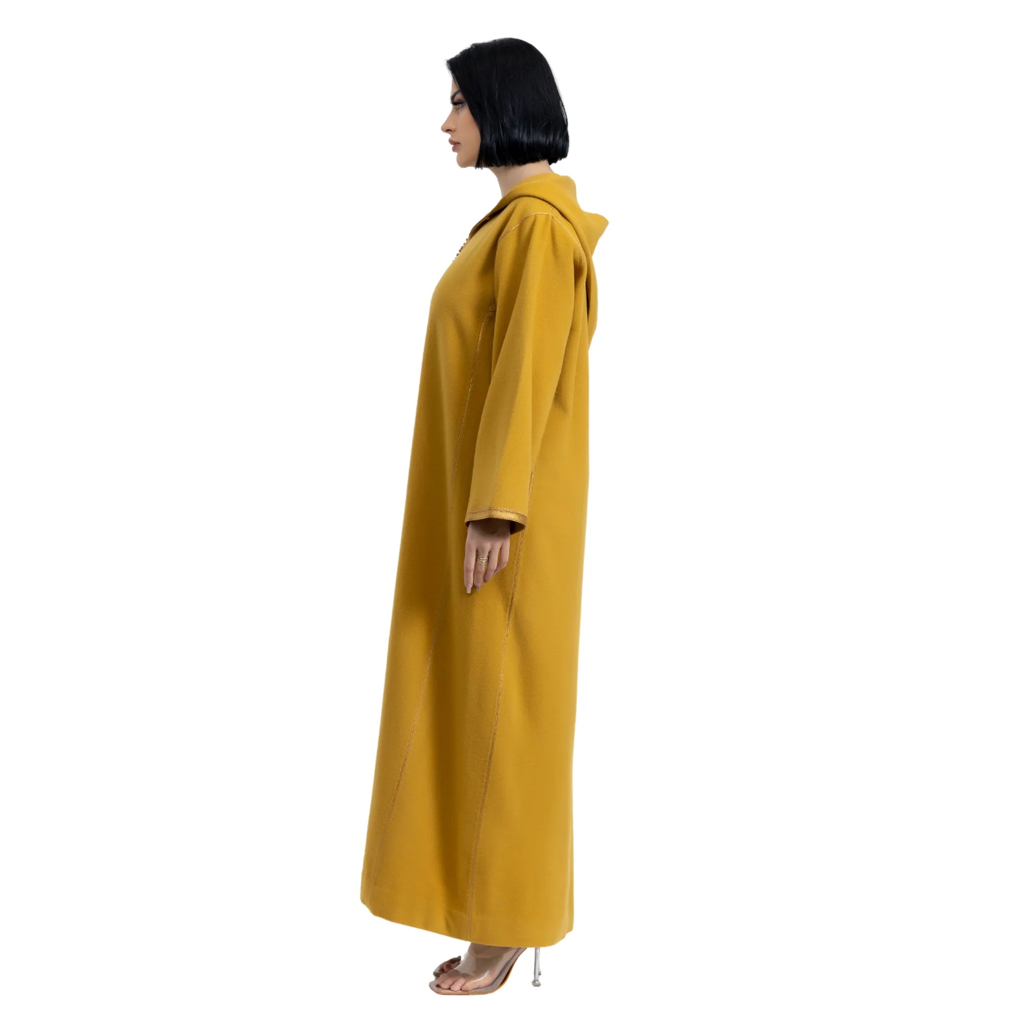 Women wearing a mustard yellow jalabiya on a white background