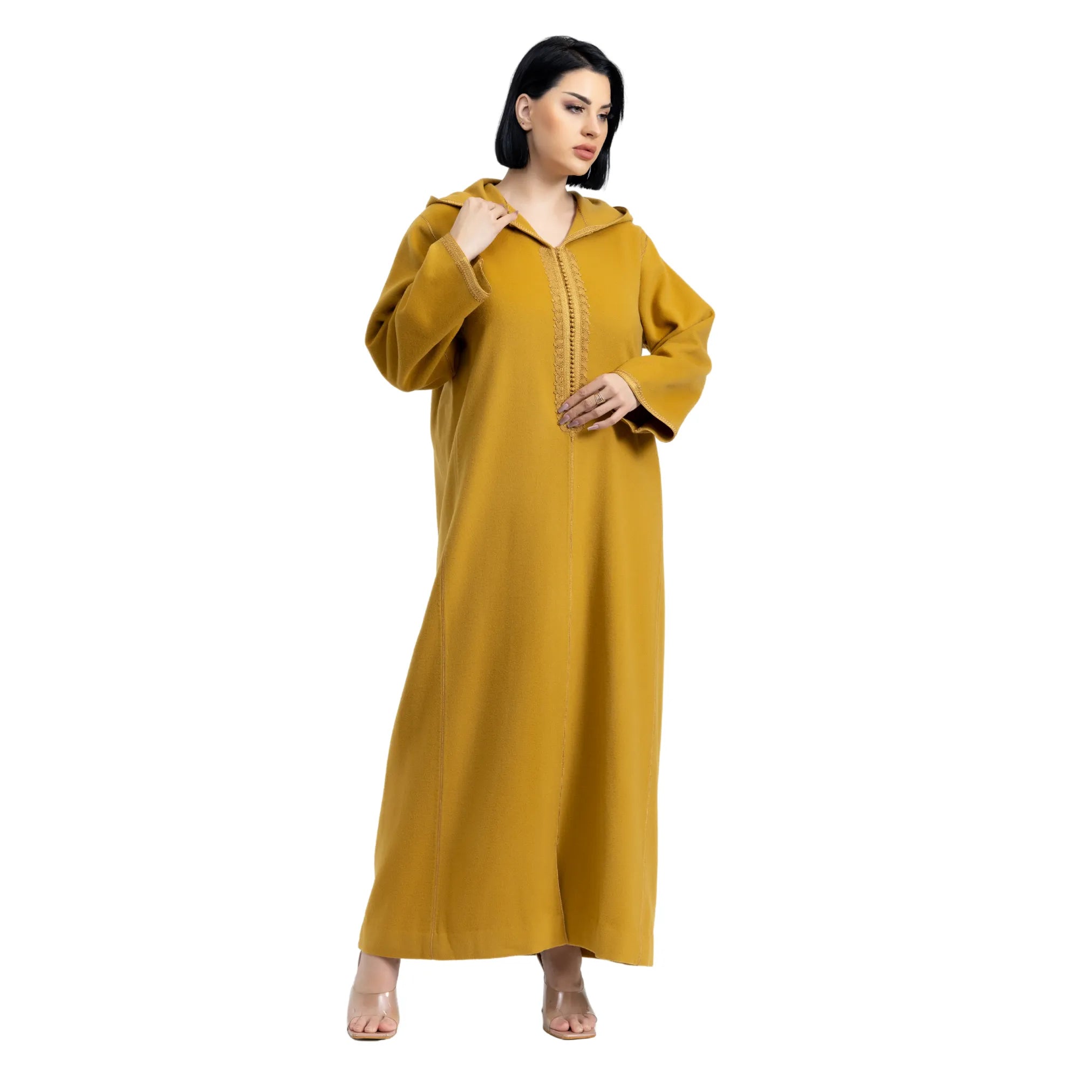 Woman wearing a mustard yellow jalabiya with a white background