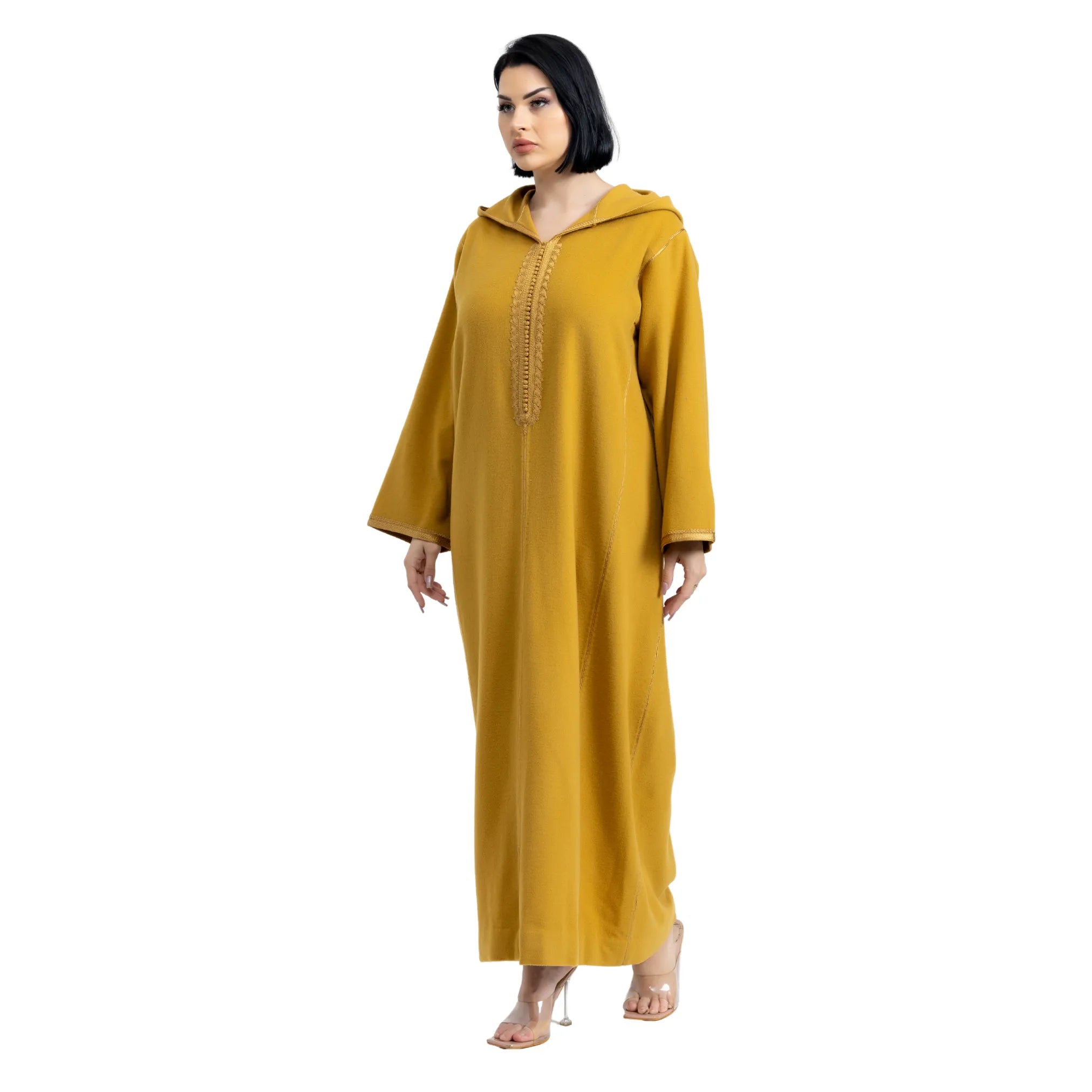 Mustard yellow jalabiya with intricate detailing on a white background