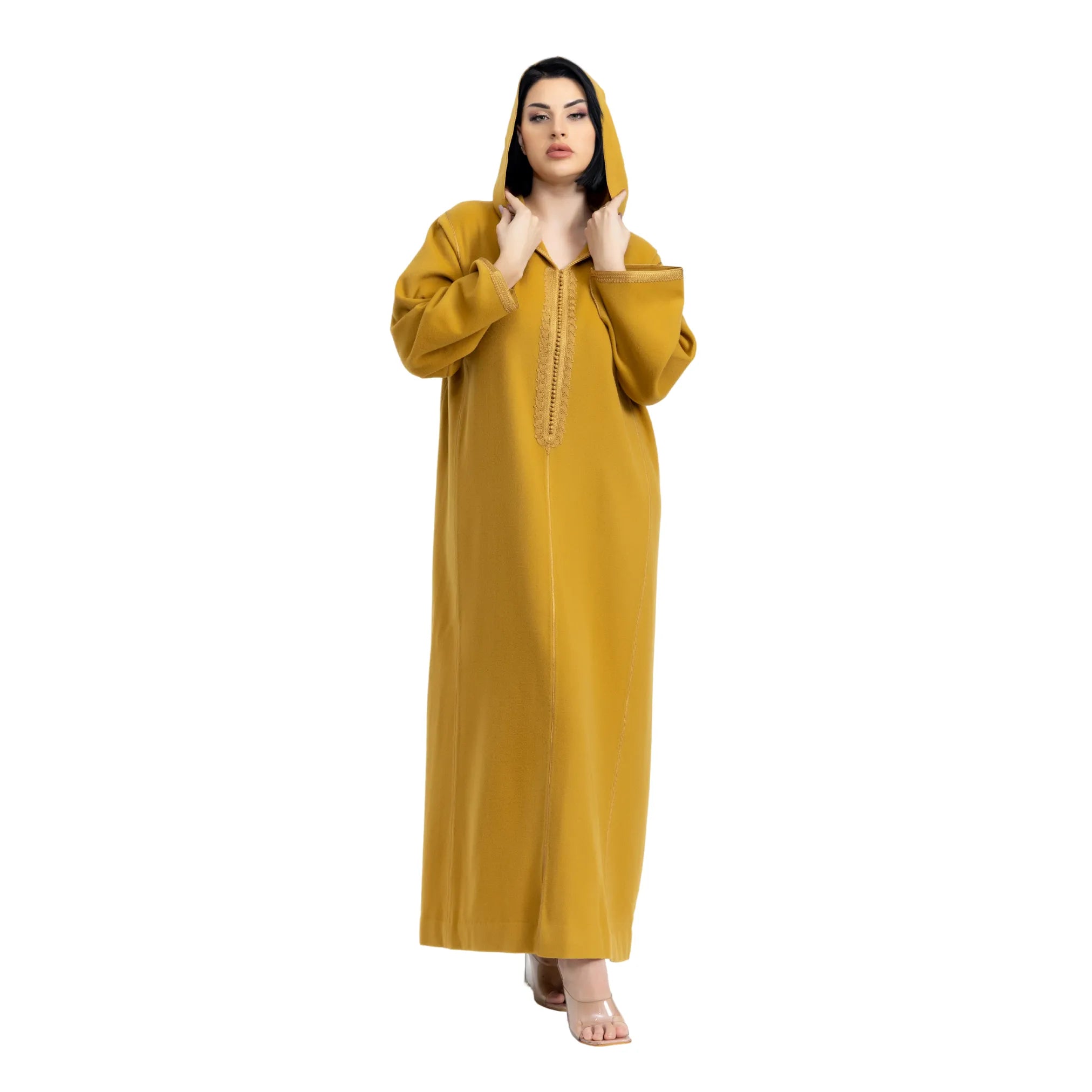 Woman wearing a mustard yellow jalabiya with a white background