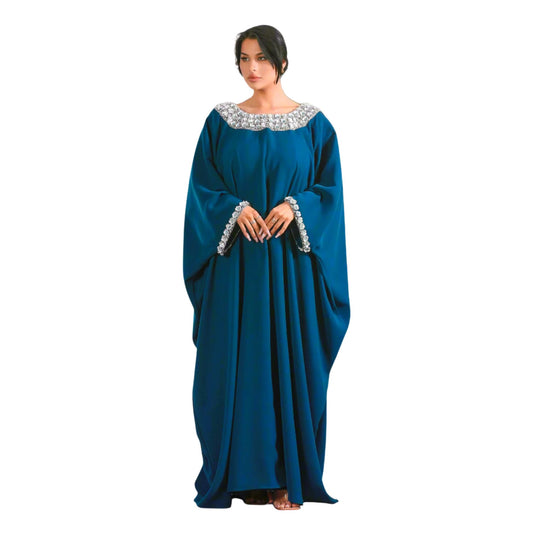 Woman wearing a blue Jalabiya with decorative neckline on a white background