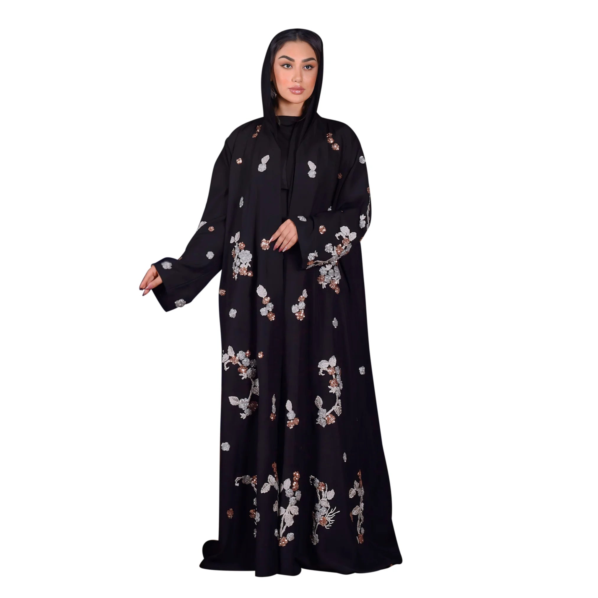 Woman wearing a black abaya with floral patterns on a white background