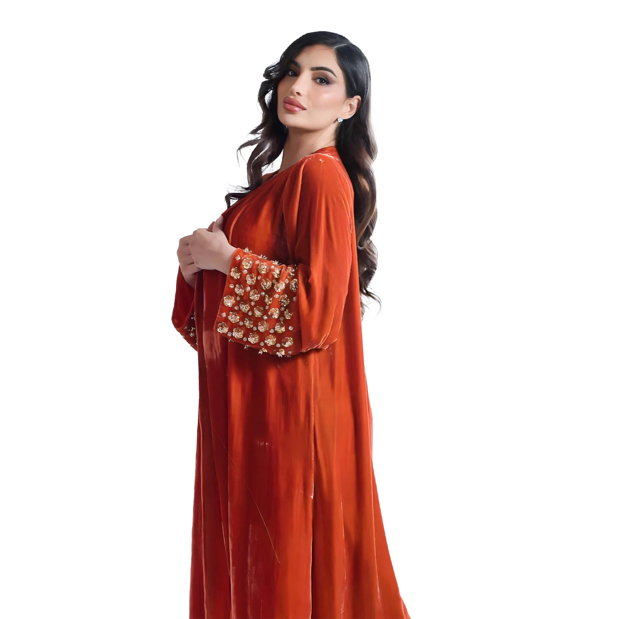 Woman wearing an orange traditional abaya outfit with floral patterns on a white background