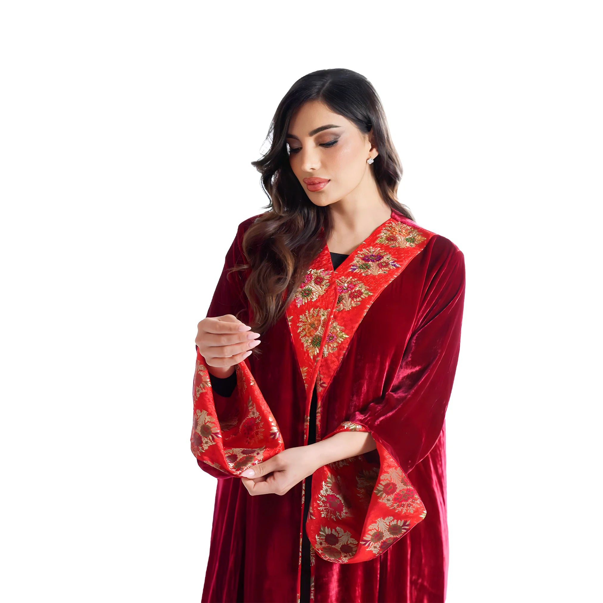 Woman wearing a red embroidered traditional abaya outfit on a white background