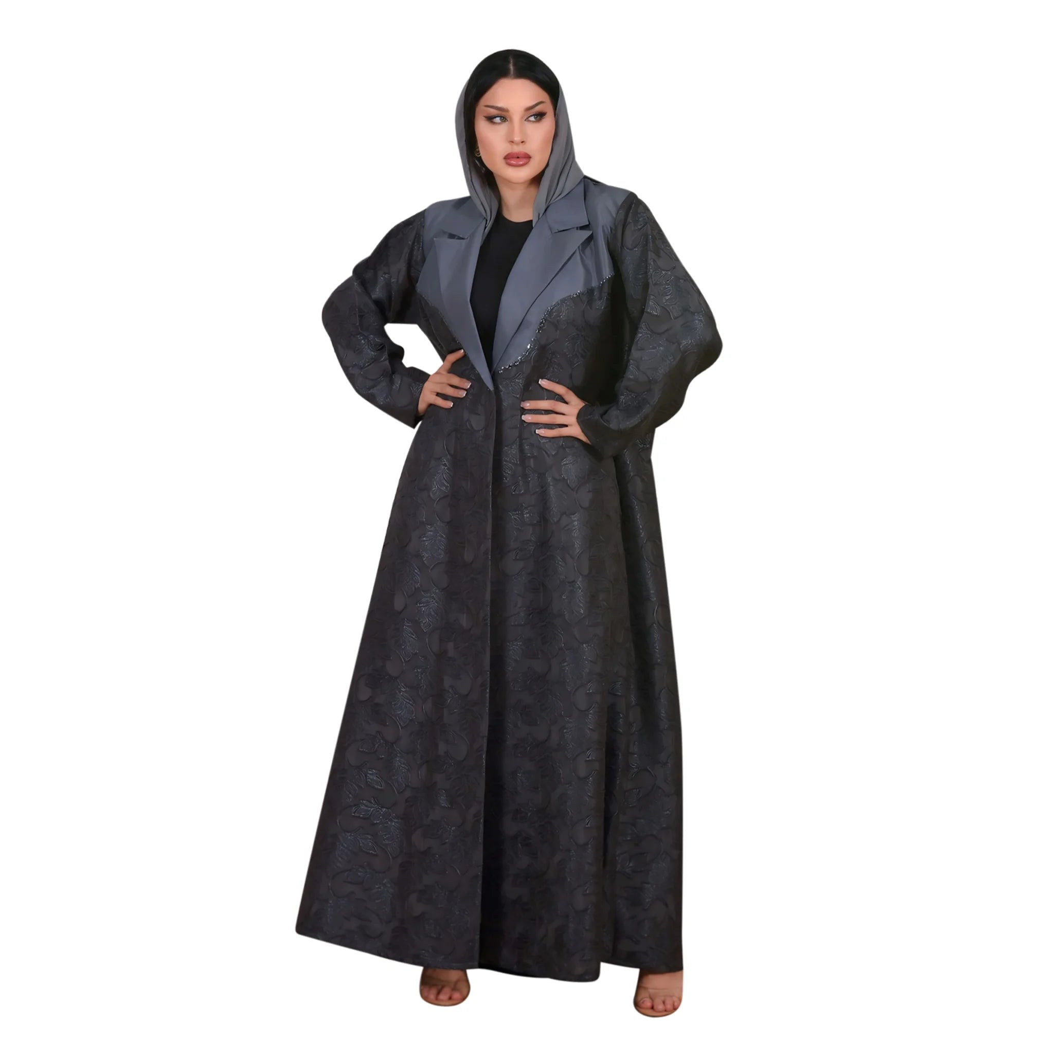 Person wearing a long dark gray abaya on a white background
