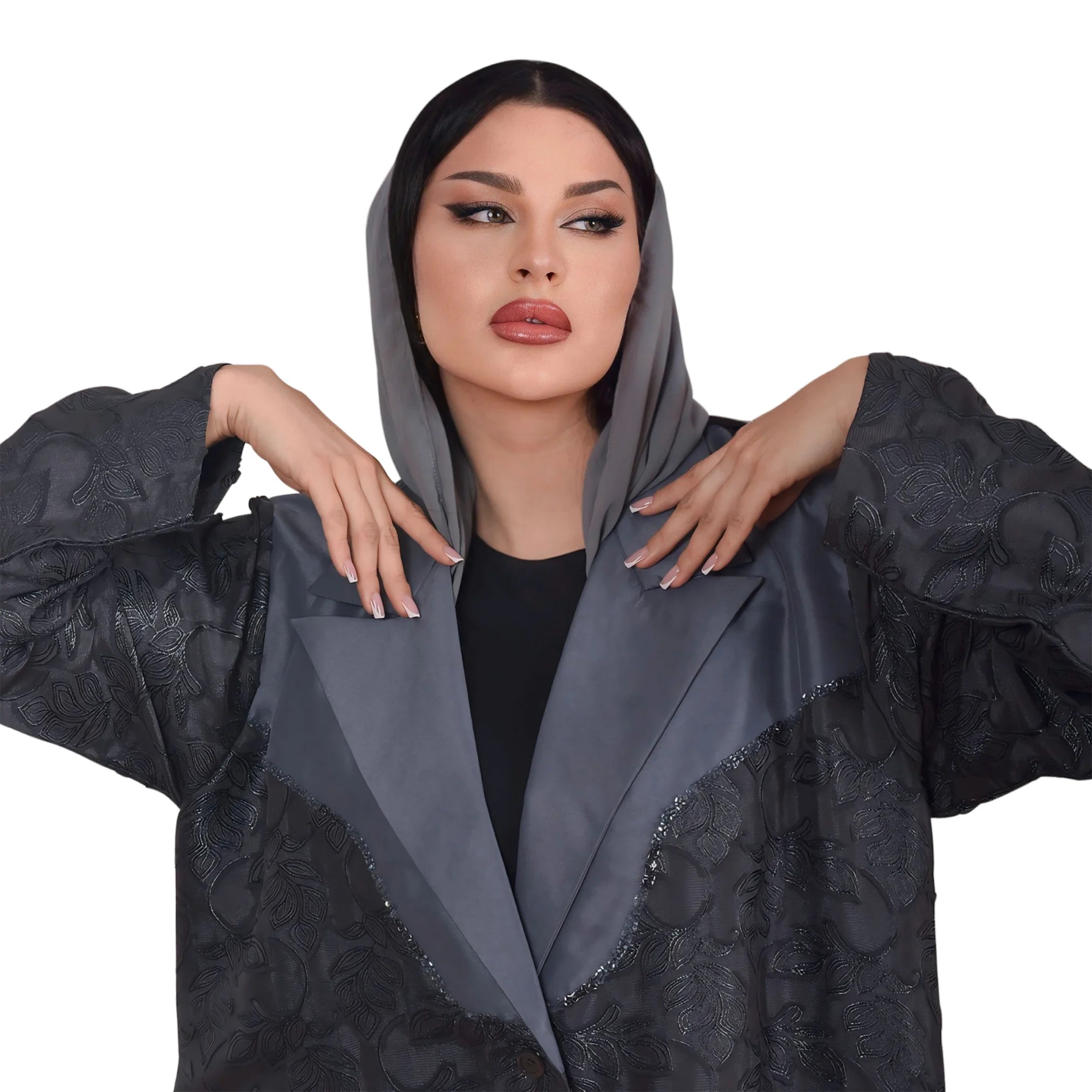 Woman wearing a dark gray embroidered abaya on a white background