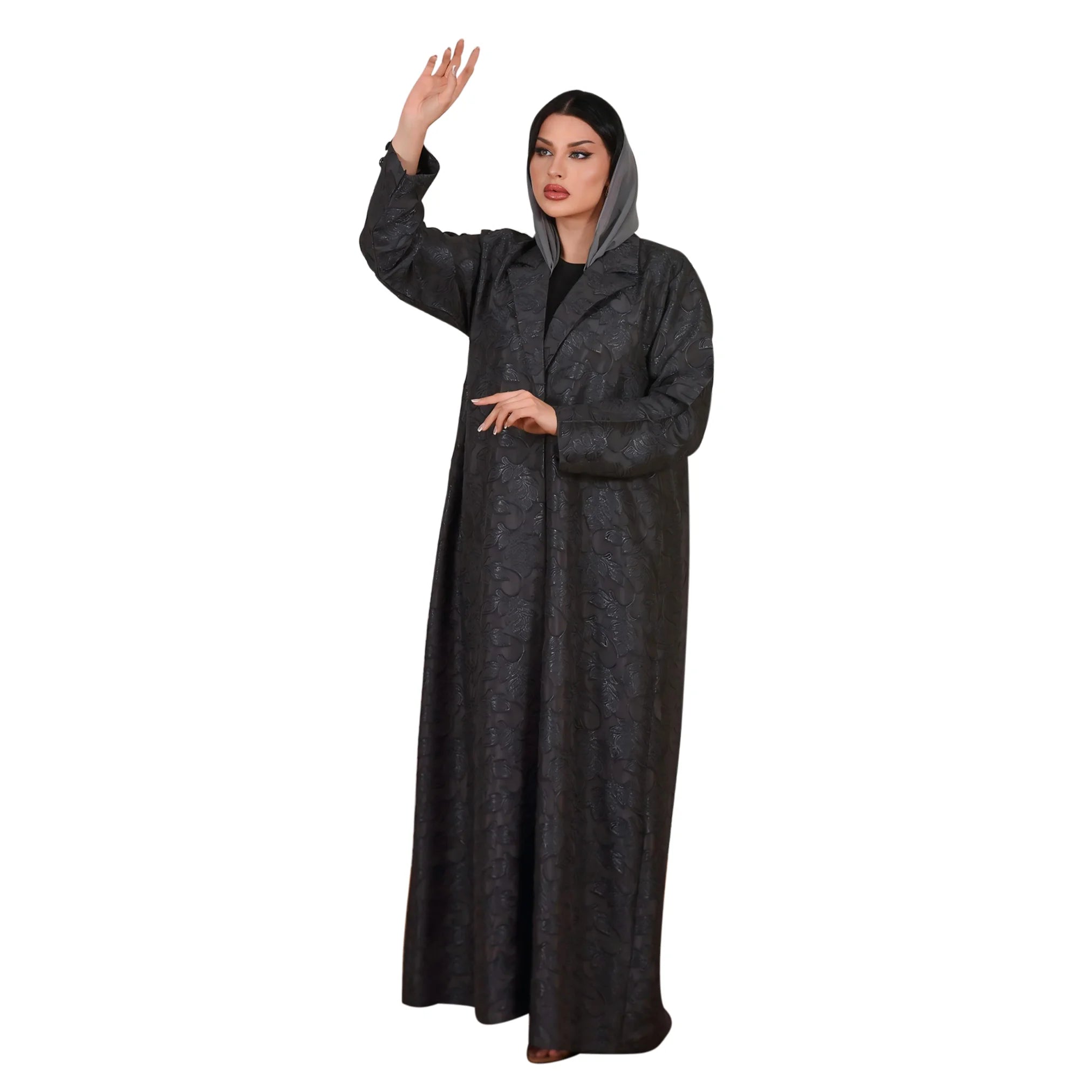 Woman wearing a long dark gray abaya on a white background