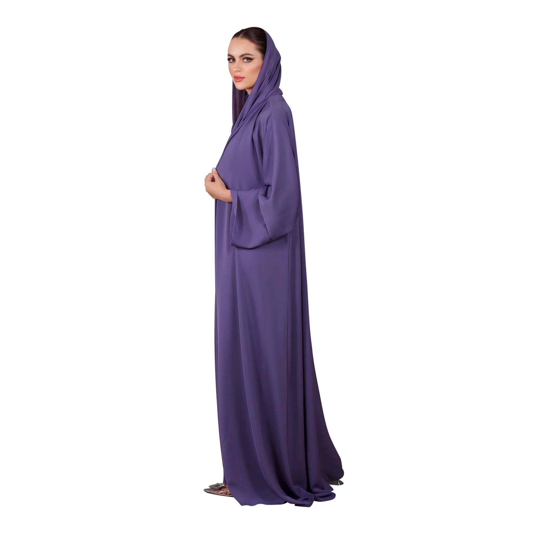 Woman wearing a long purple abaya with a hood on a white background