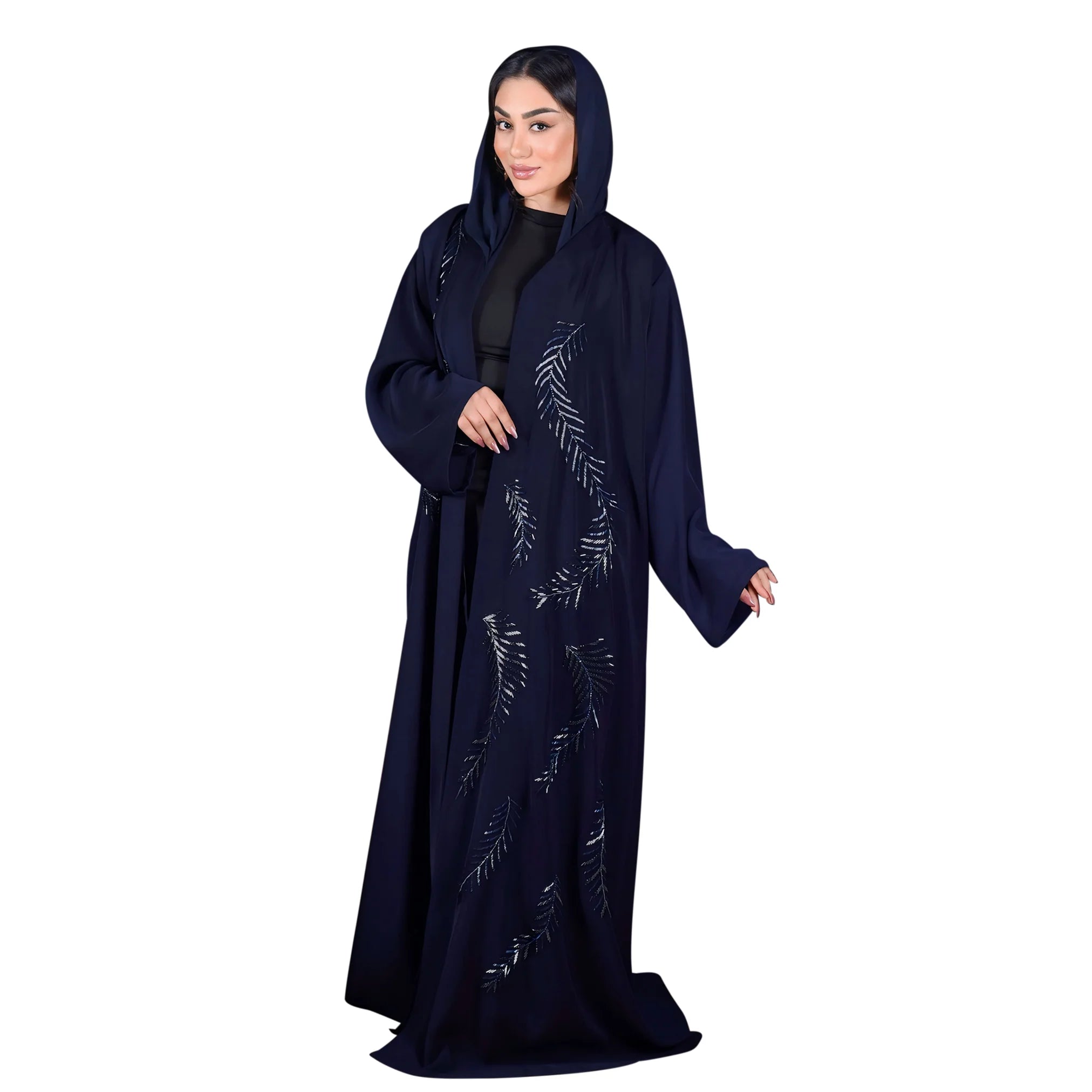 Woman wearing a dark blue abaya with floral patterns on a white background