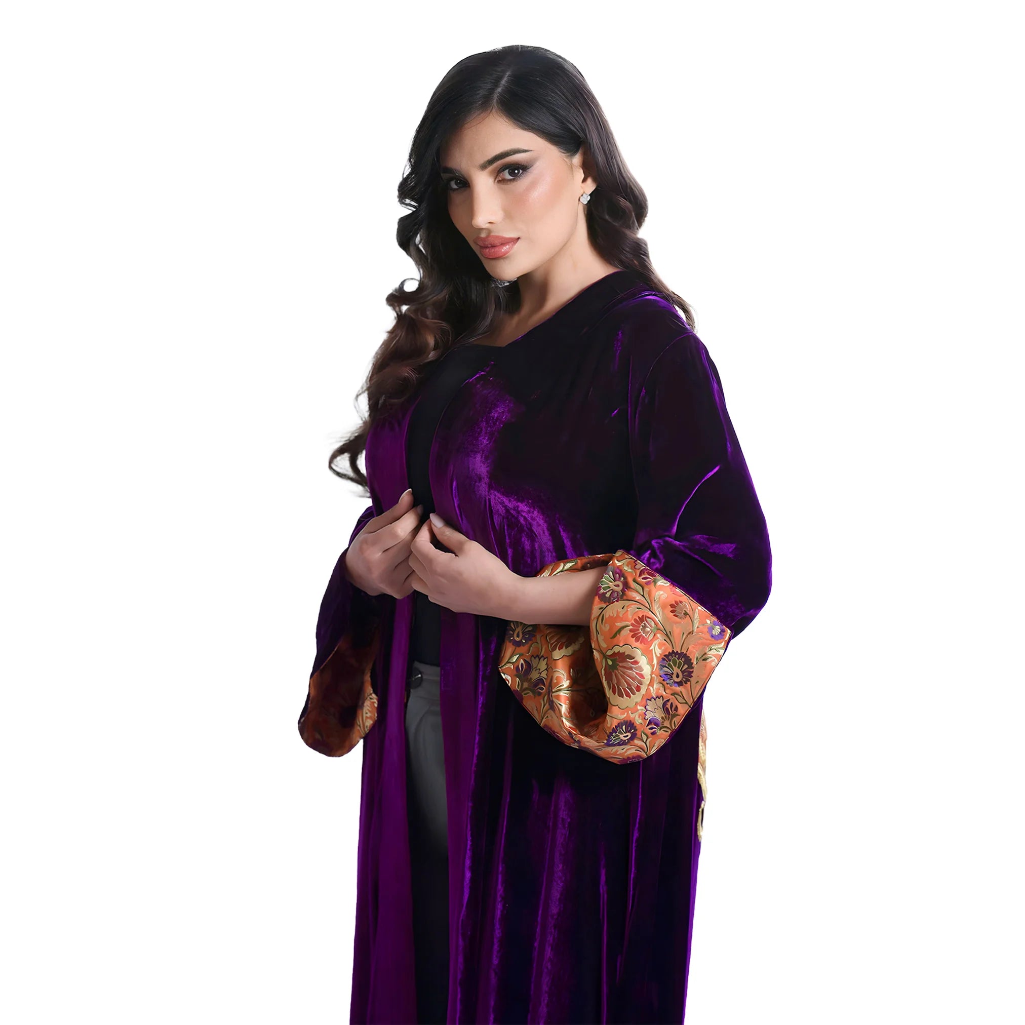 Woman wearing a purple dress with a patterned clutch on a white background