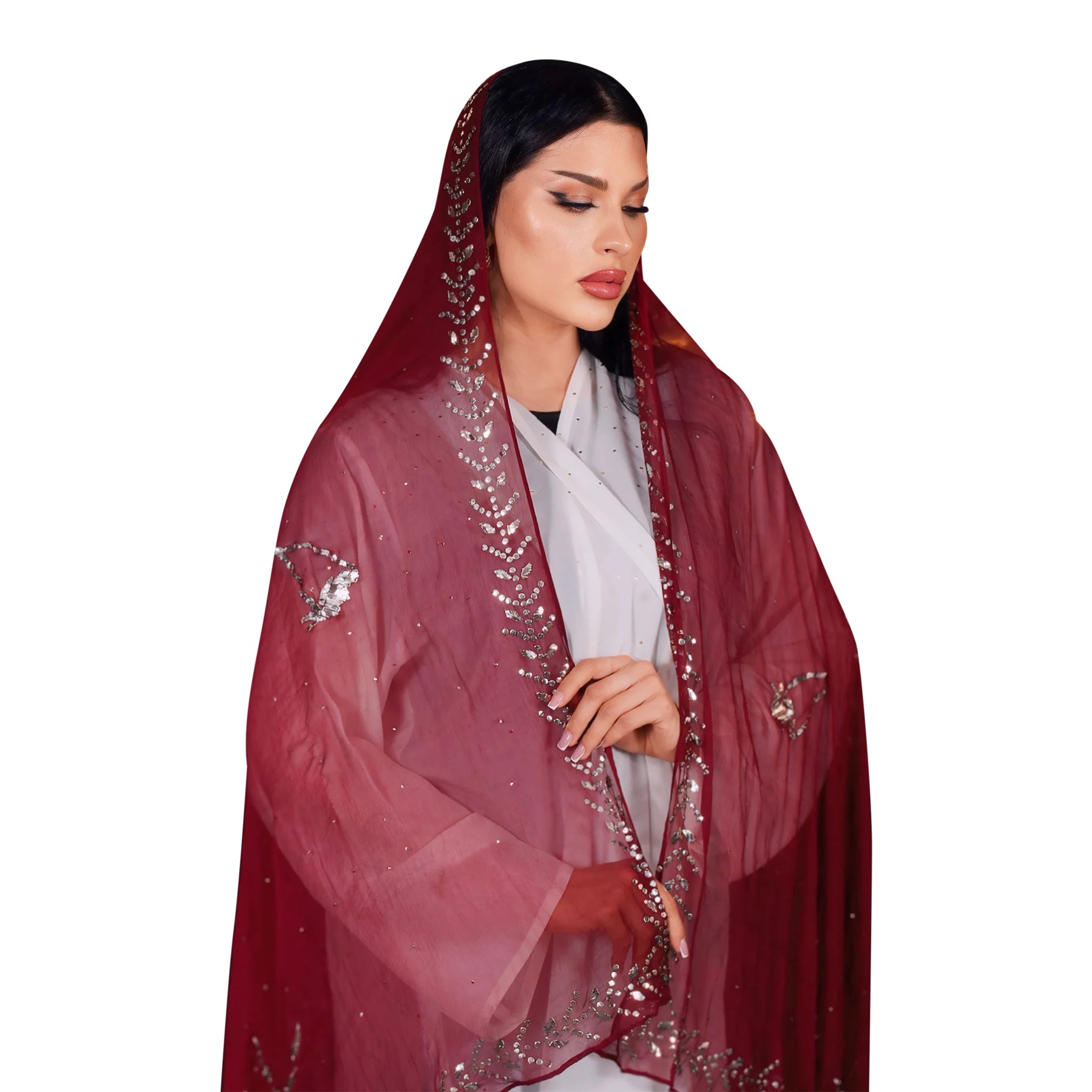 Woman wearing a red embroidered abaya on a white background. Qatar National Day