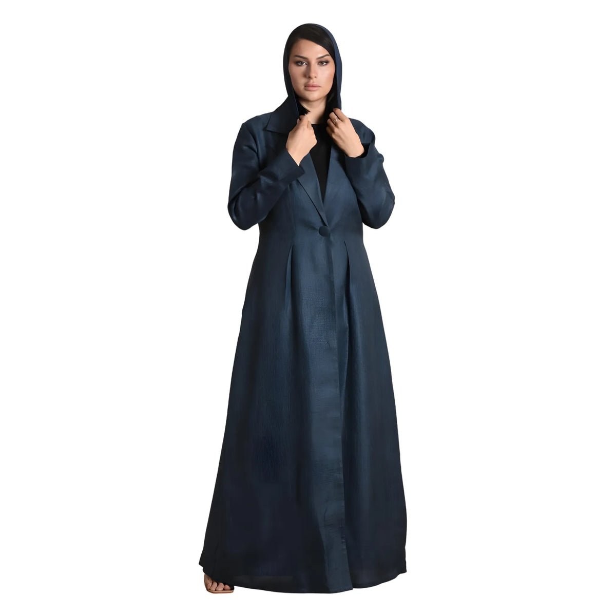 Woman wearing a long dark blue abaya on a white background