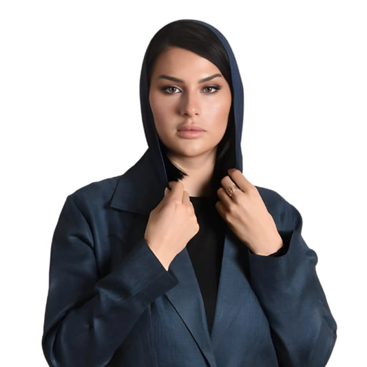 Woman wearing a dark blue hooded abaya on a white background