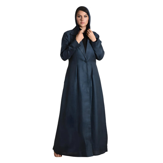 Woman wearing a long dark blue abaya on a white background