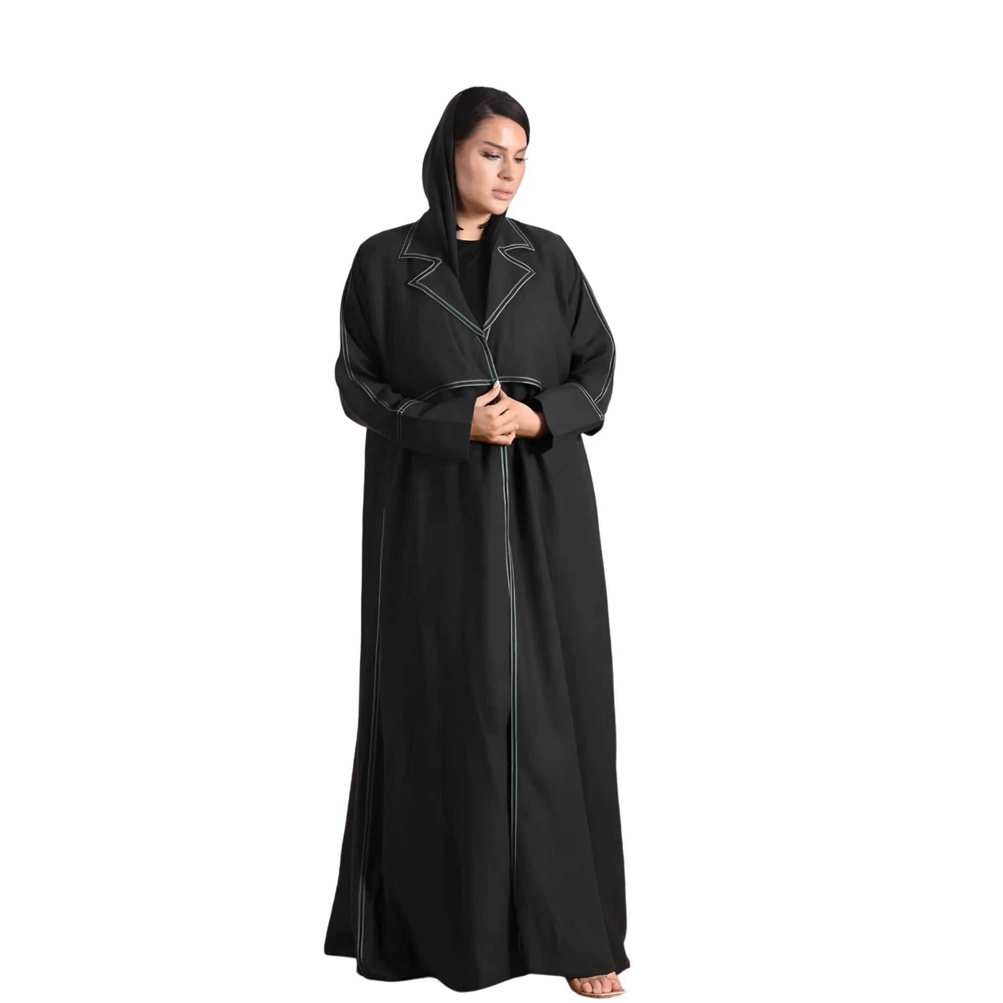 Woman wearing a black abaya with white trim on a white background
