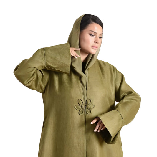 Woman wearing a green hooded coat with a decorative flower on a white background