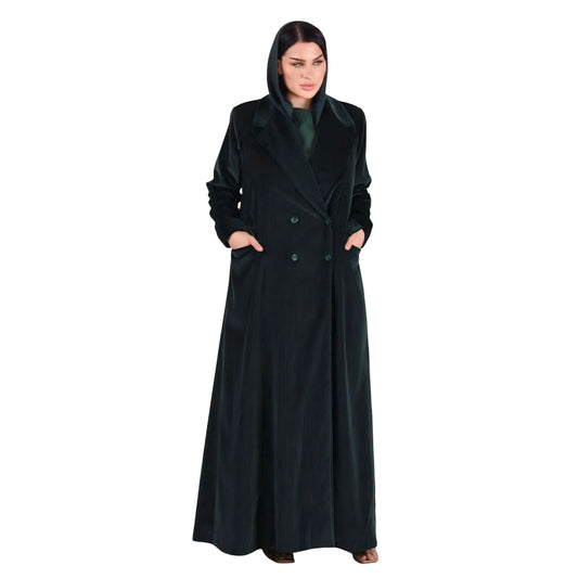 Woman wearing a long Emerald Green abaya on a white background