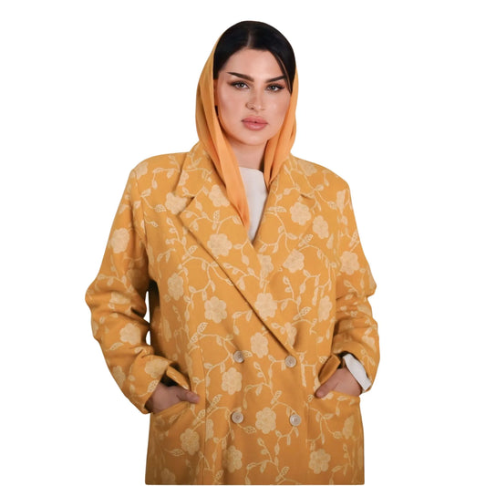 Woman wearing a yellow floral coat on a white background