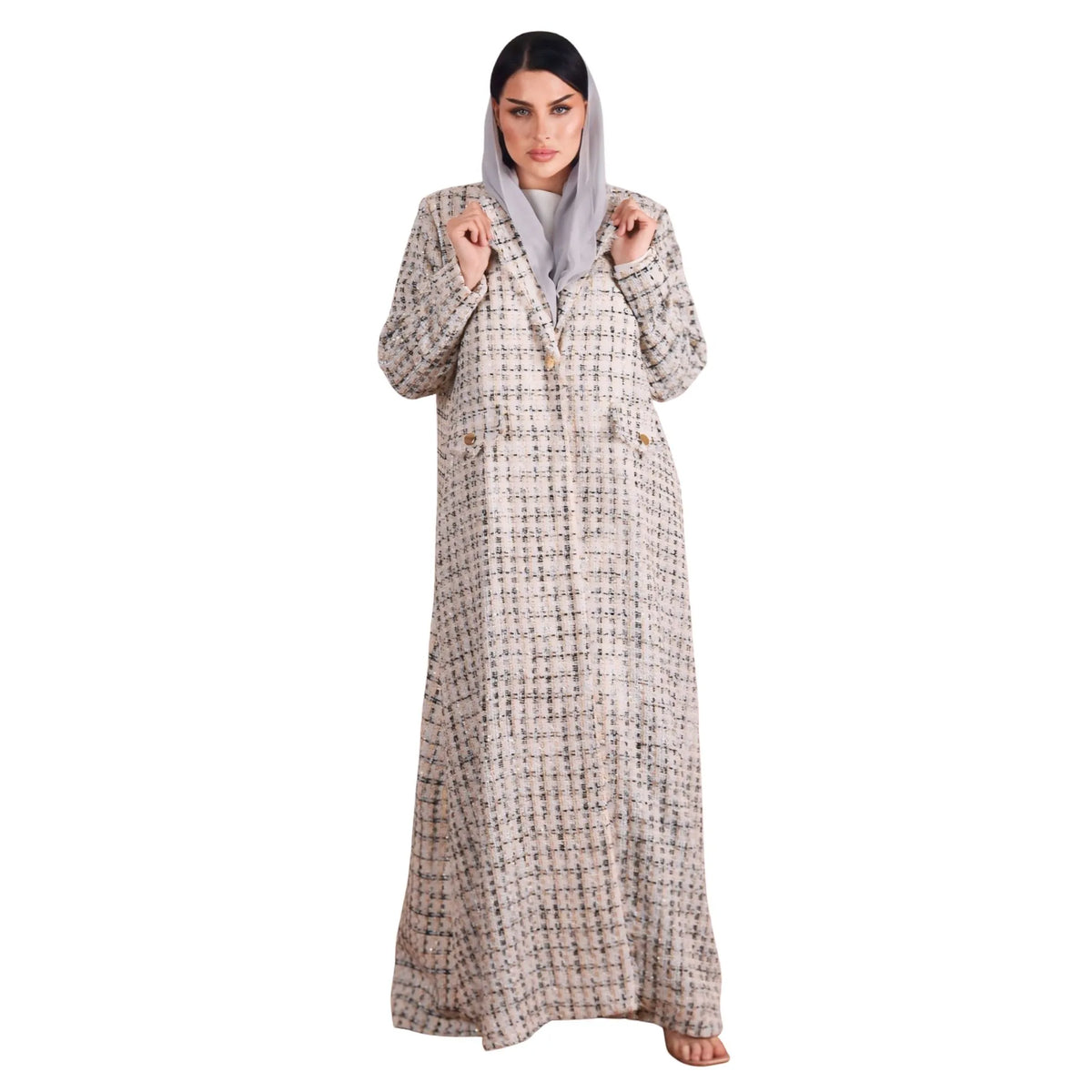 Woman wearing a long, patterned abaya on a white background