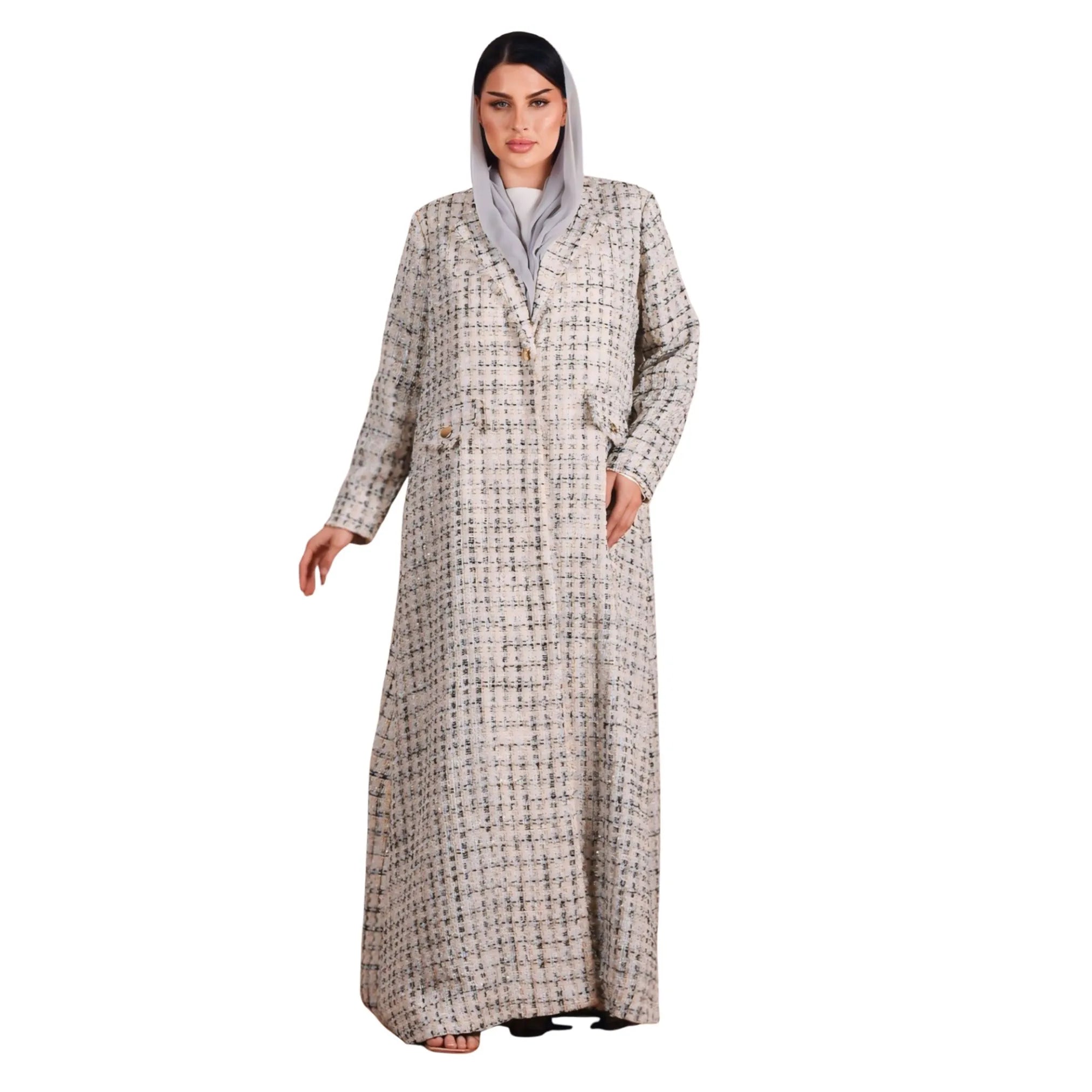 Woman wearing a long, patterned coat on a white background