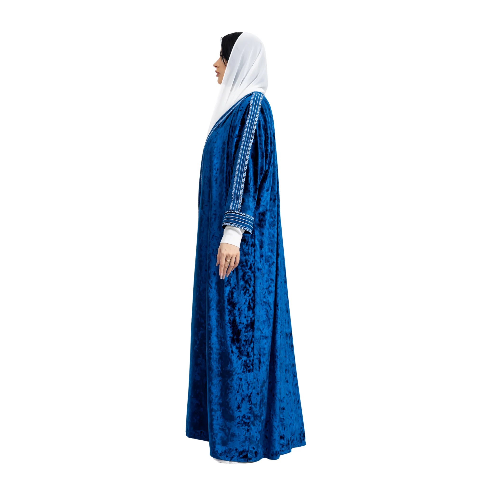 Woman wearing a blue abaya with white hijab on a white background