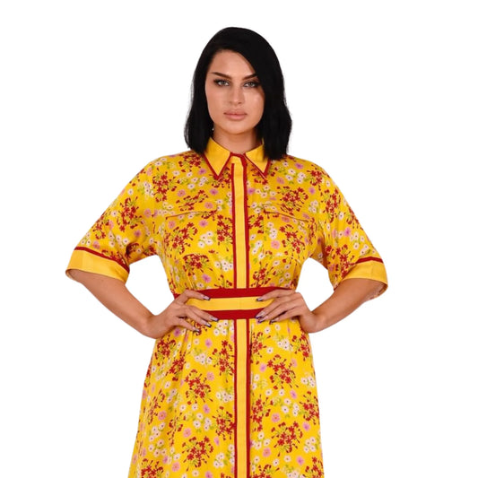 Woman wearing a yellow floral dress with a red zipper on a white background