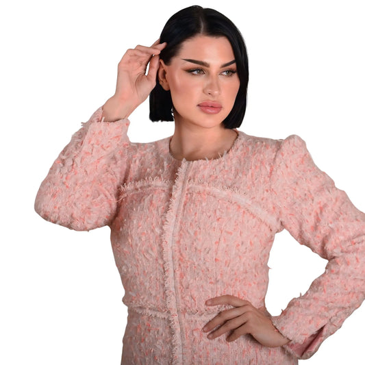 Woman wearing a pink textured dress on a white background