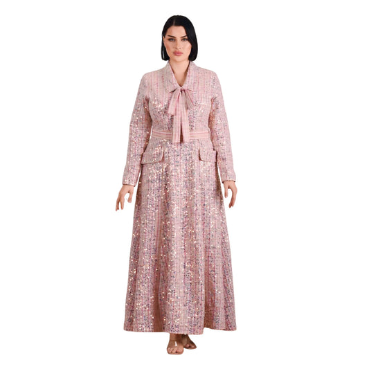 Woman wearing a long, patterned dress with a belt on a white background