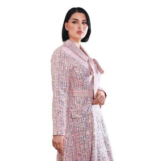 Woman wearing a patterned dress with a white background