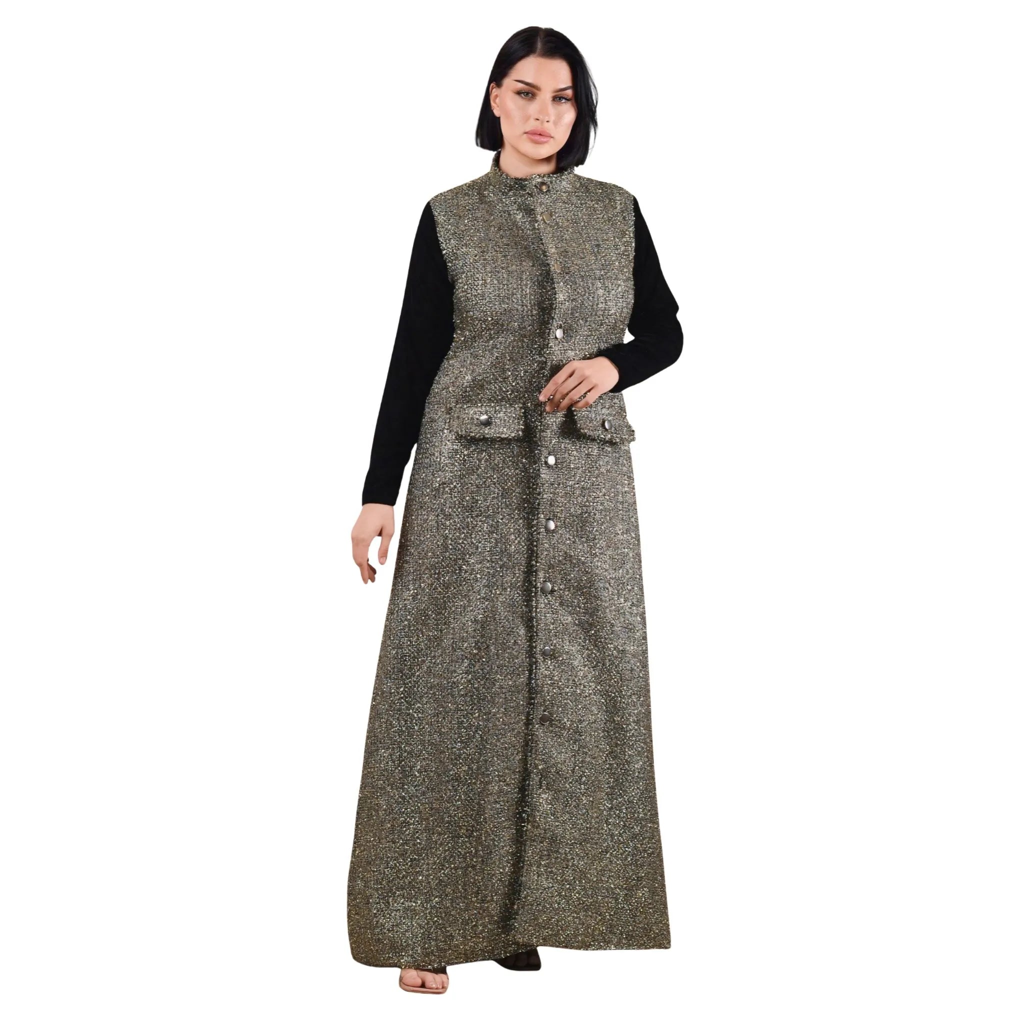 Woman wearing a long, patterned vest over a black top on a white background