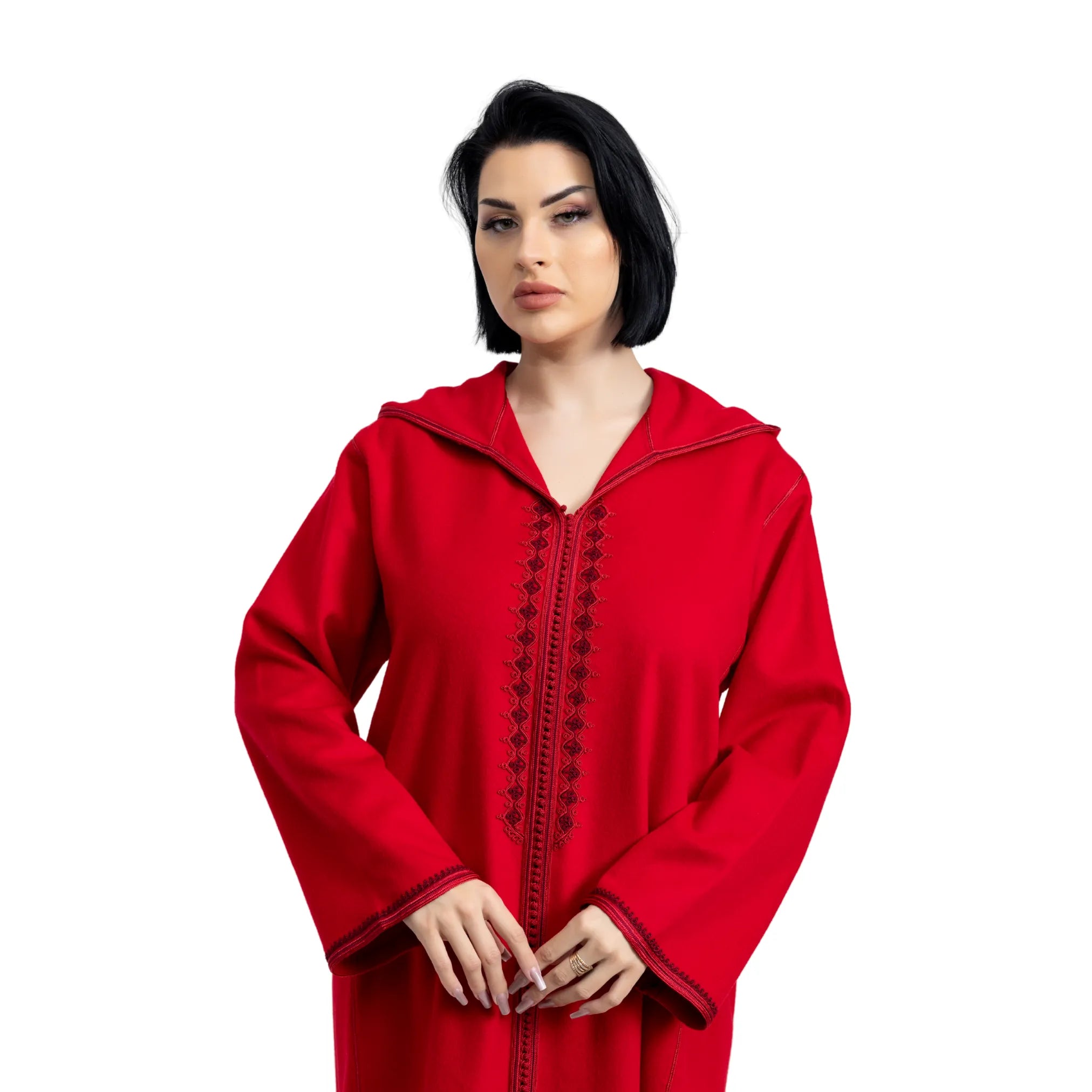 Woman wearing a red hooded jalabiya with black embroidery on a white background
