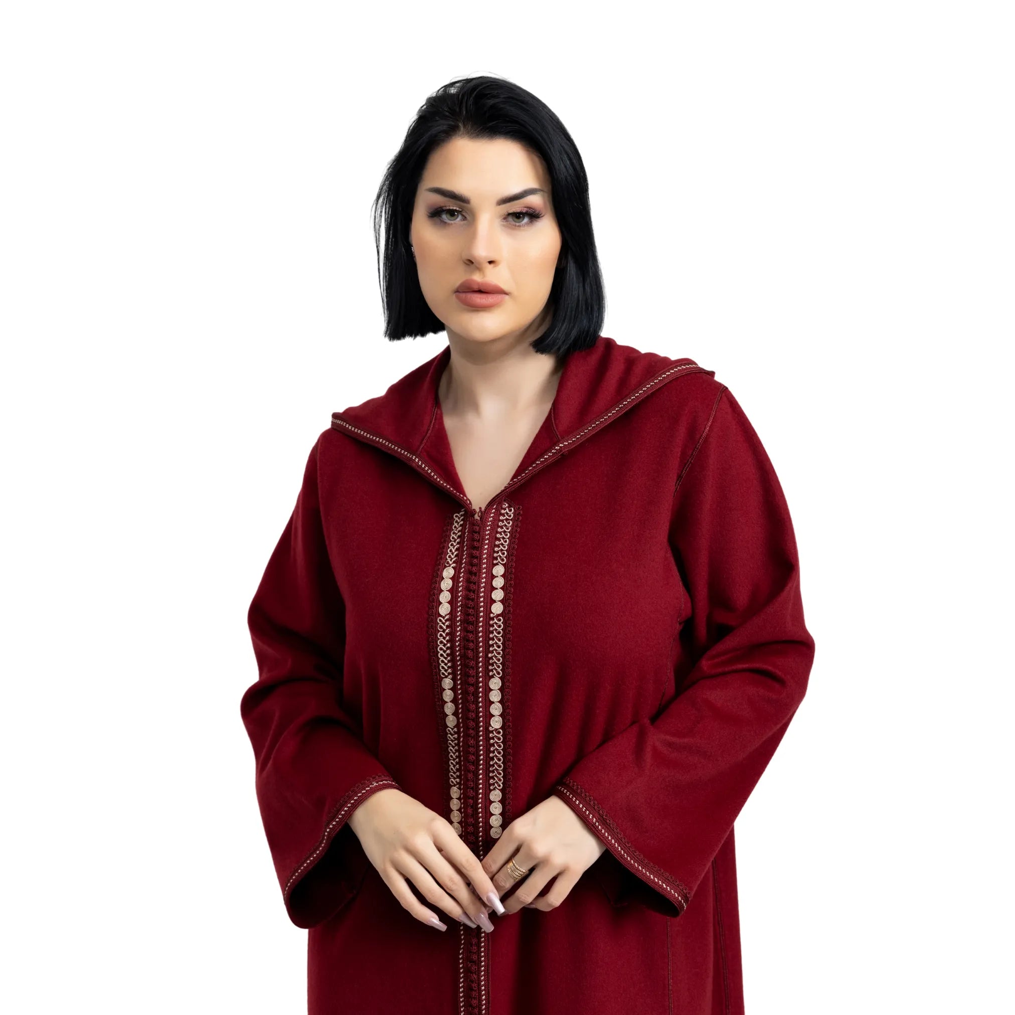 Woman wearing a red hooded Jalabiya with intricate detailing on a white background